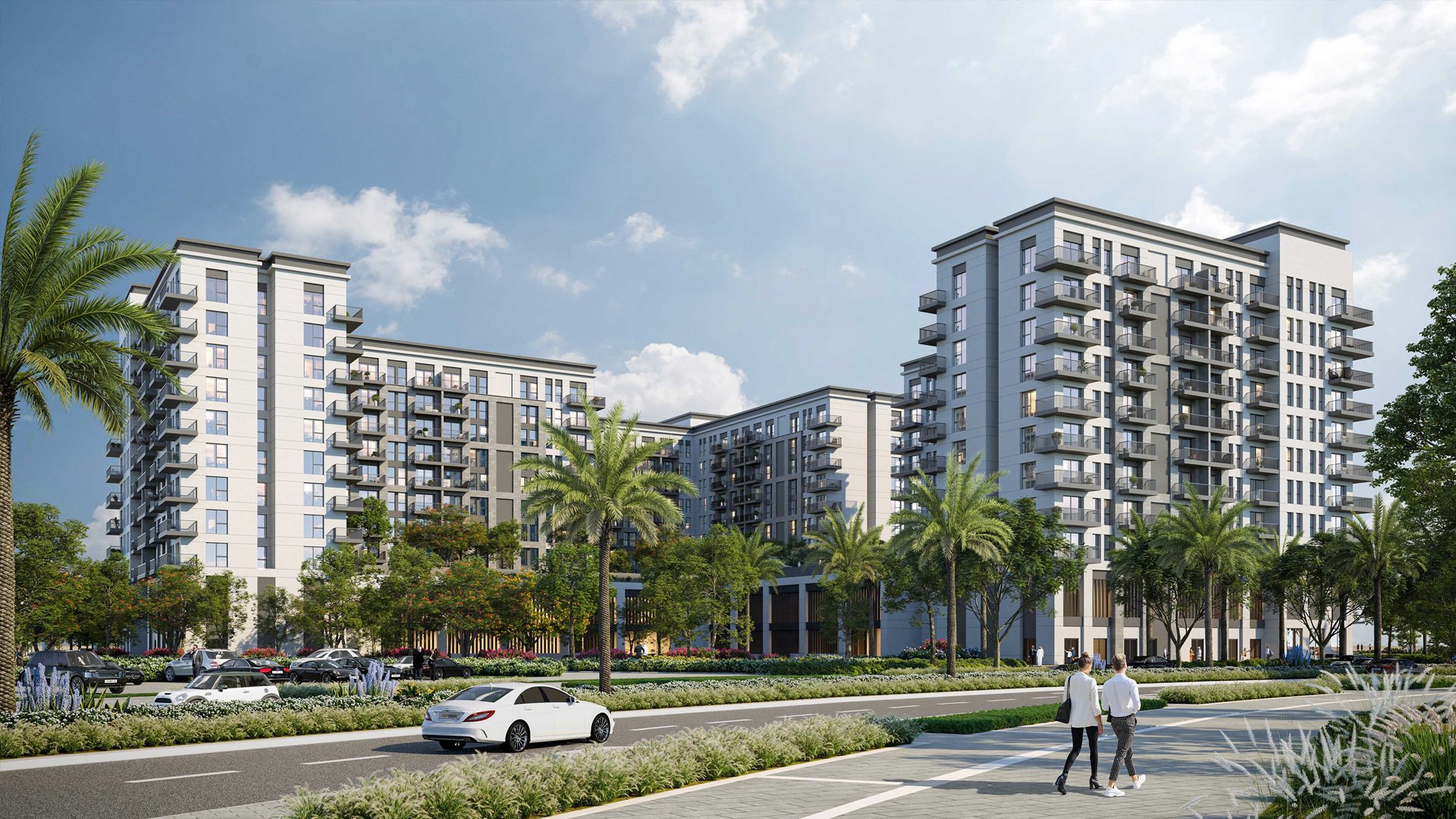 Eagle Hills. Maryam Island CGI. Dubai Real estate marketing. Modern multi-story apartment complex with surrounding landscaping and palm trees, cars parked along the street, and two people walking on the sidewalk under a partly cloudy sky.