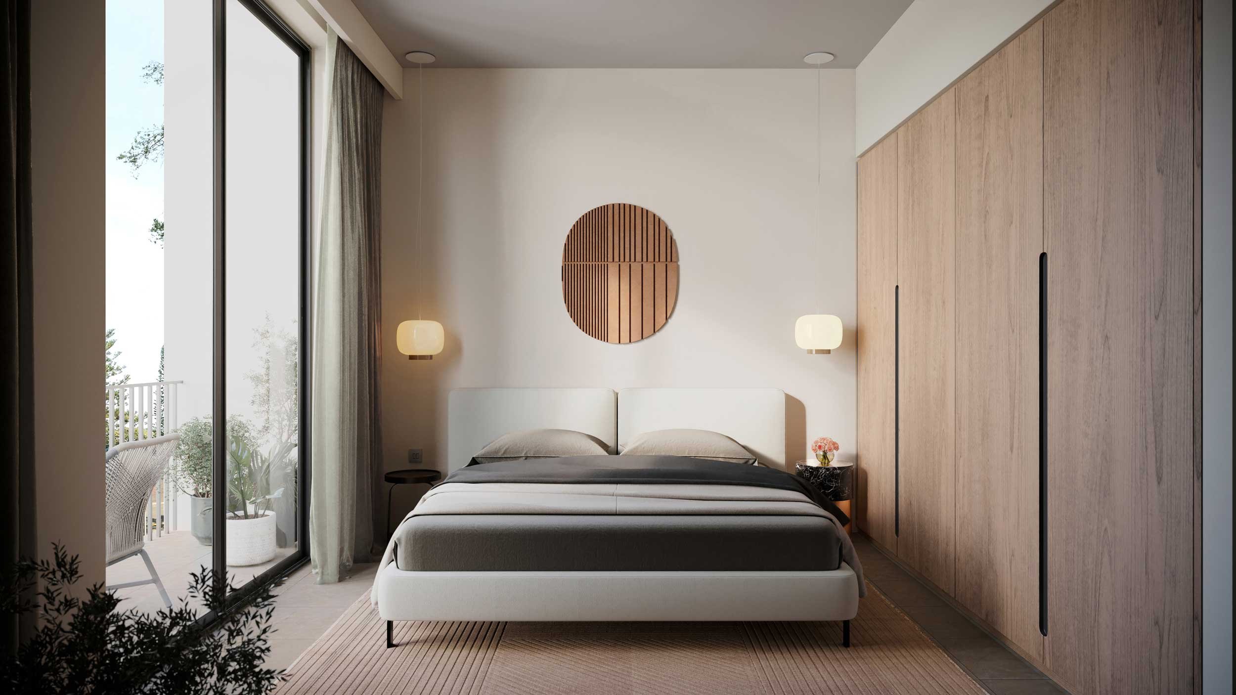 Modern bedroom with a white bed, grey bedding, two bedside lamps, and a circular wooden wall art above the headboard, large window with curtains, sliding glass door leading to a balcony with outdoor furniture and potted plants.