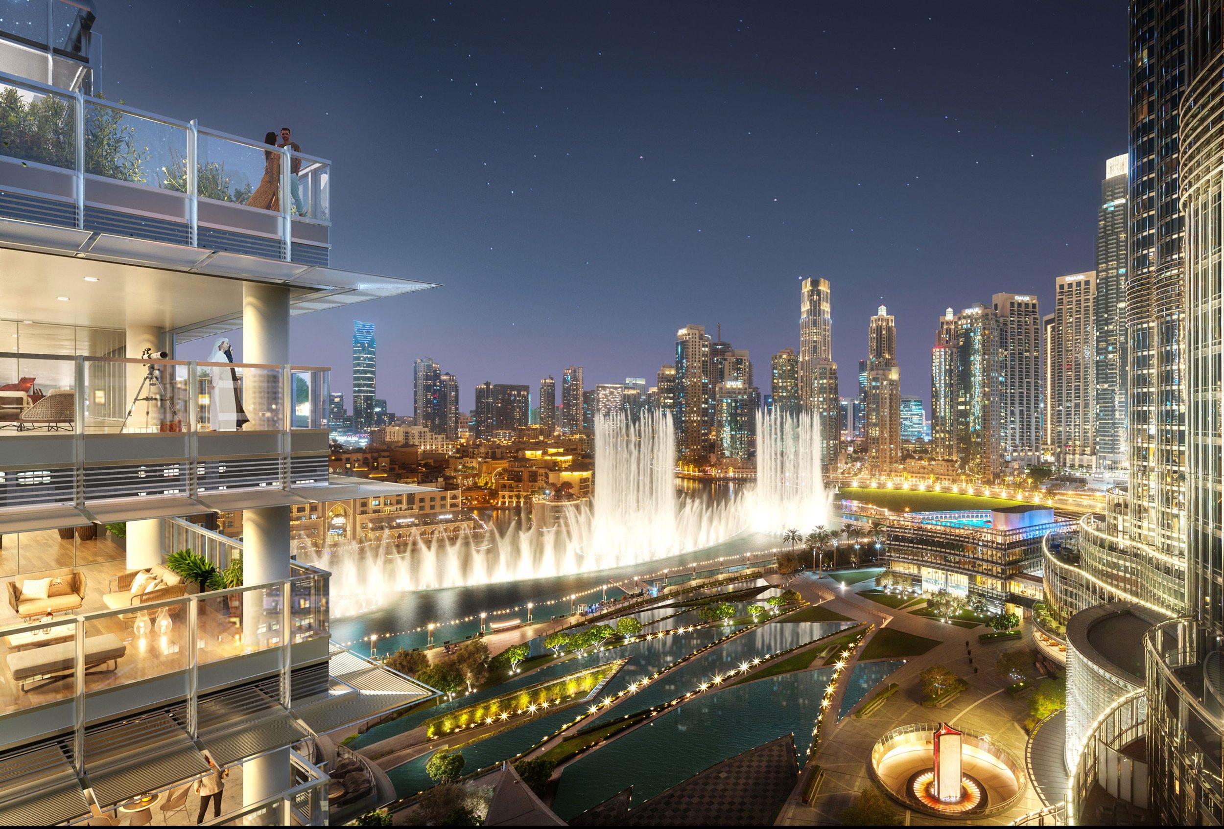 Night view of a modern city with numerous skyscrapers, a large water fountain display, and an outdoor balcony with two people looking at the cityscape.