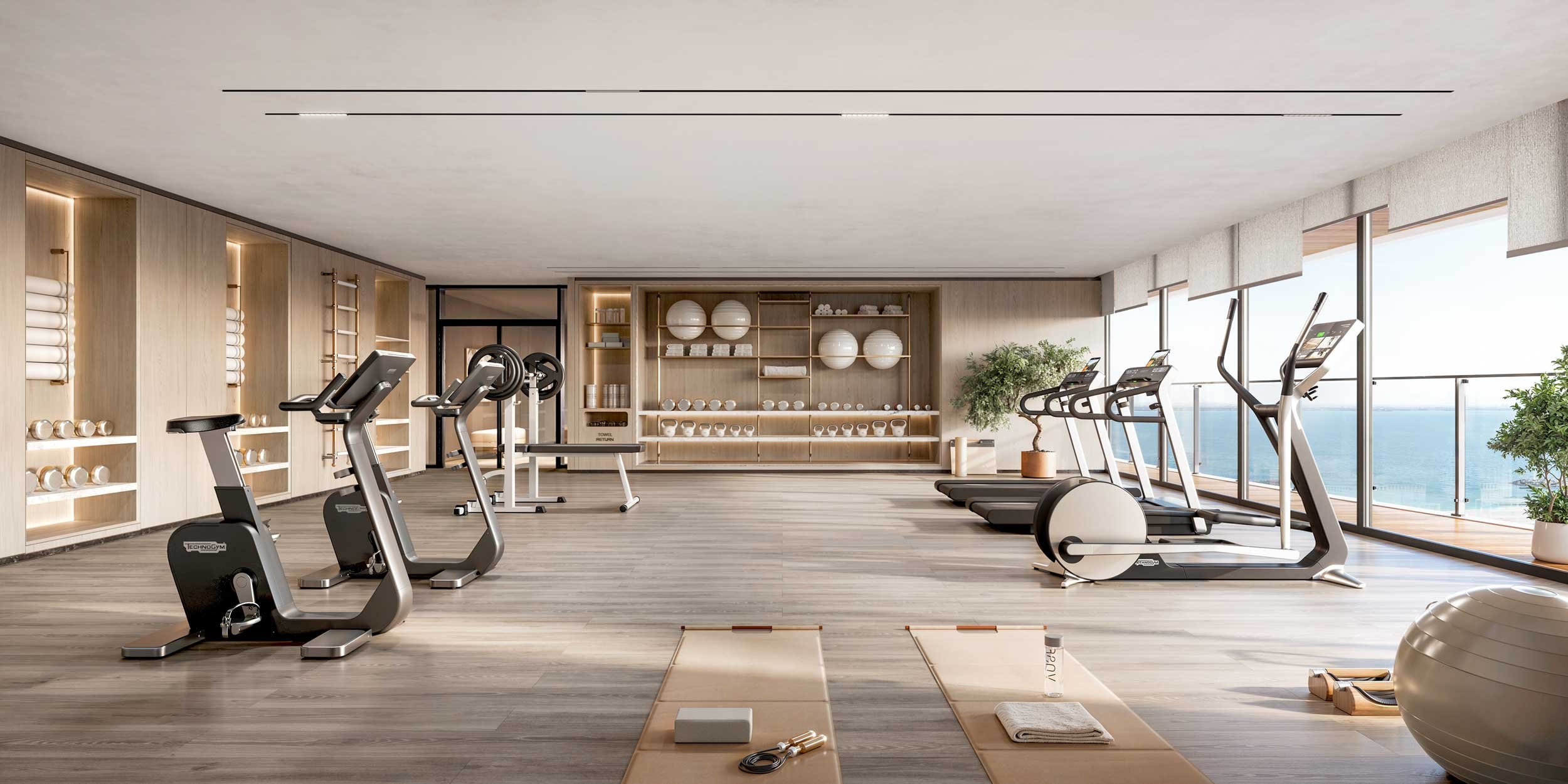 Modern gym room with exercise bikes, treadmills, and yoga mats, overlooking an ocean view through large windows. Lacasa Living. Al Marjan Island . CGI.  Dubai Real Estate Marketing.