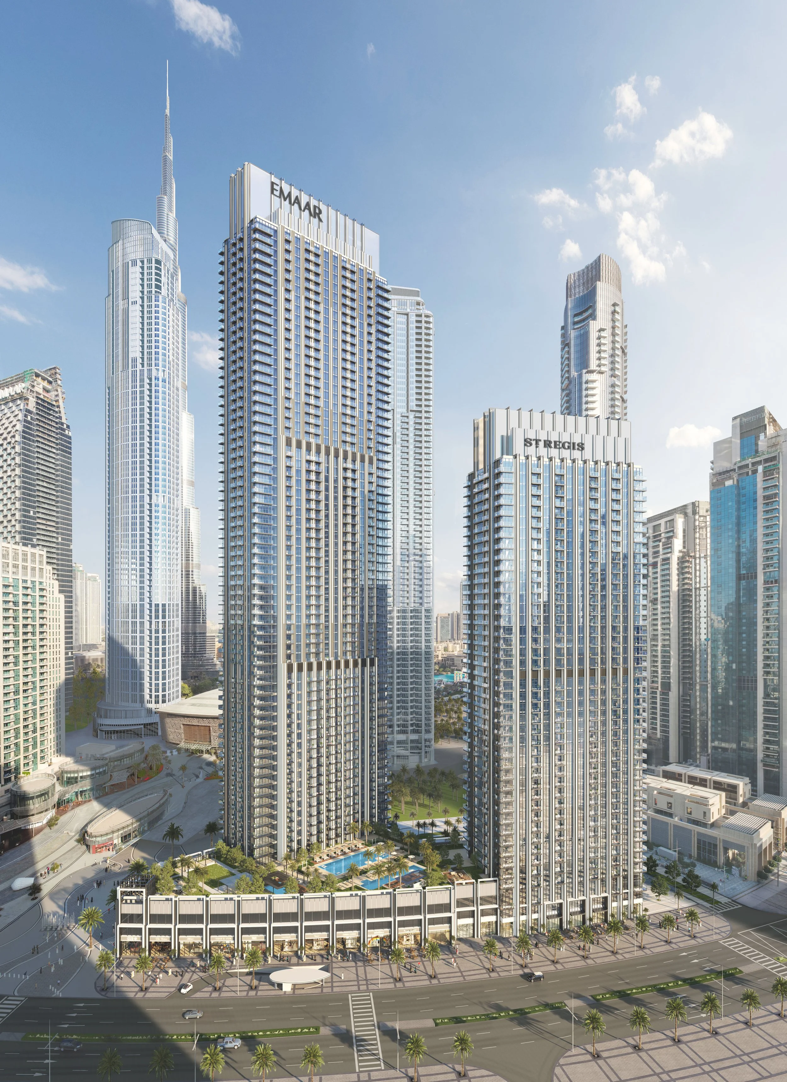 Modern high-rise buildings in a city skyline, including the Emaar and St. Regis towers, with a pool and palm trees at their base, under a bright blue sky. Emaar. Dubai Downtown. Dubai Real estate marketing.