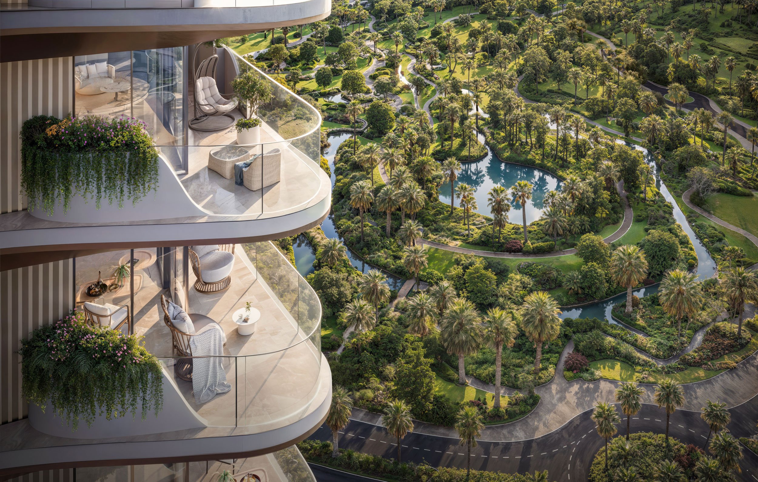 Balcony with modern outdoor furniture overlooking lush green park with trees, water features, and winding pathways.  Beyond Properties. Dubai Real Estate Marketing.