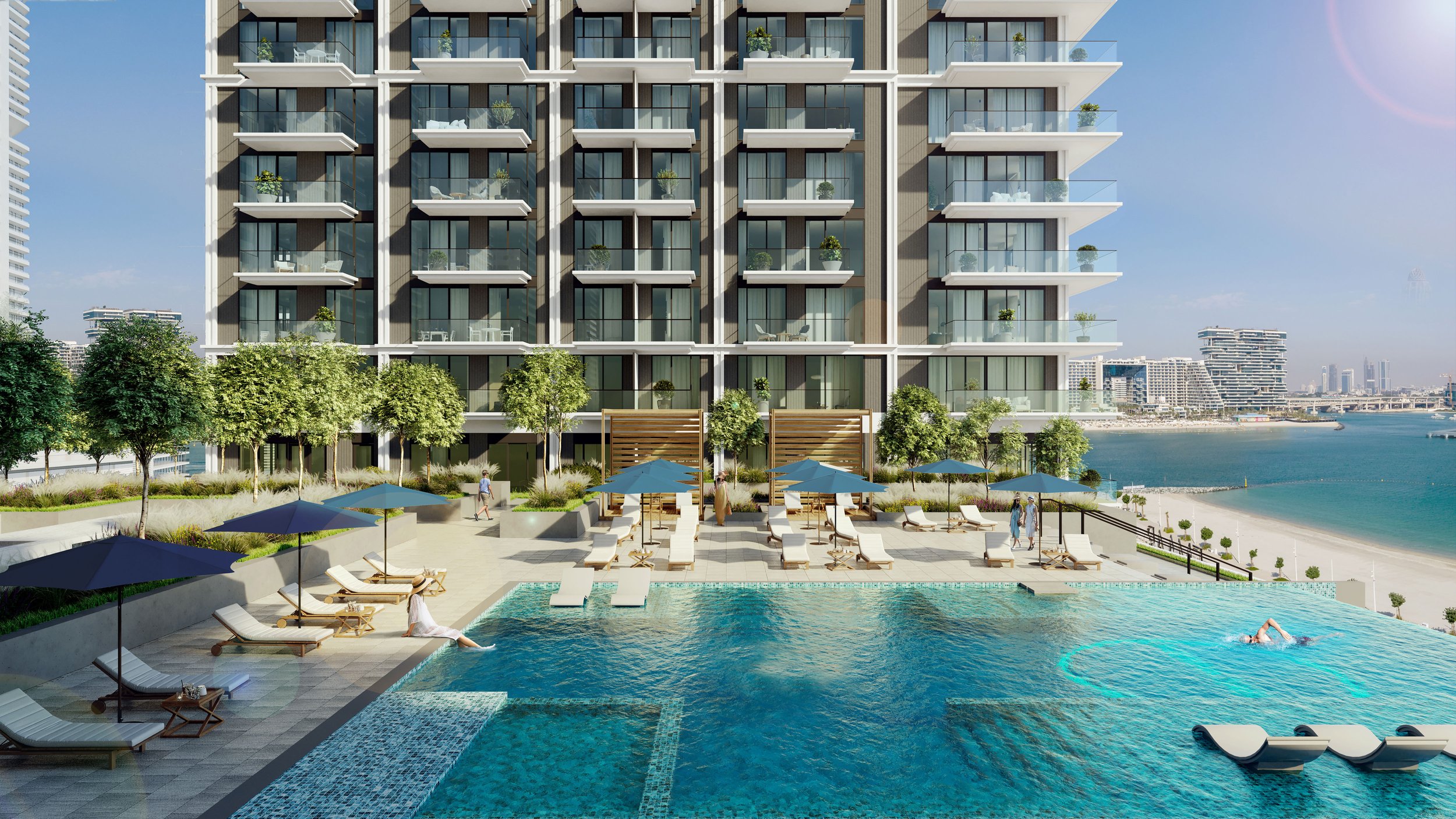 Modern high-rise apartment building with multiple balconies overlooking a swimming pool area and ocean, with lounge chairs, umbrellas, and greenery. Emaar. Dubai Marina. Dubai Real estate marketing.