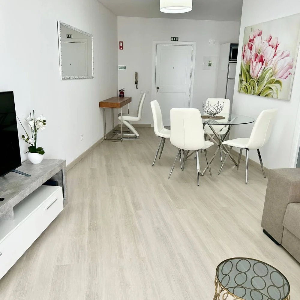 Living room with a television on a low sideboard and a console desk