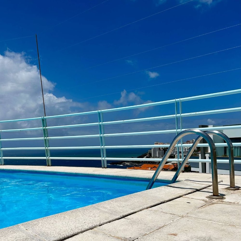 The building's rooftop swimming pool with the Atlantic beyond