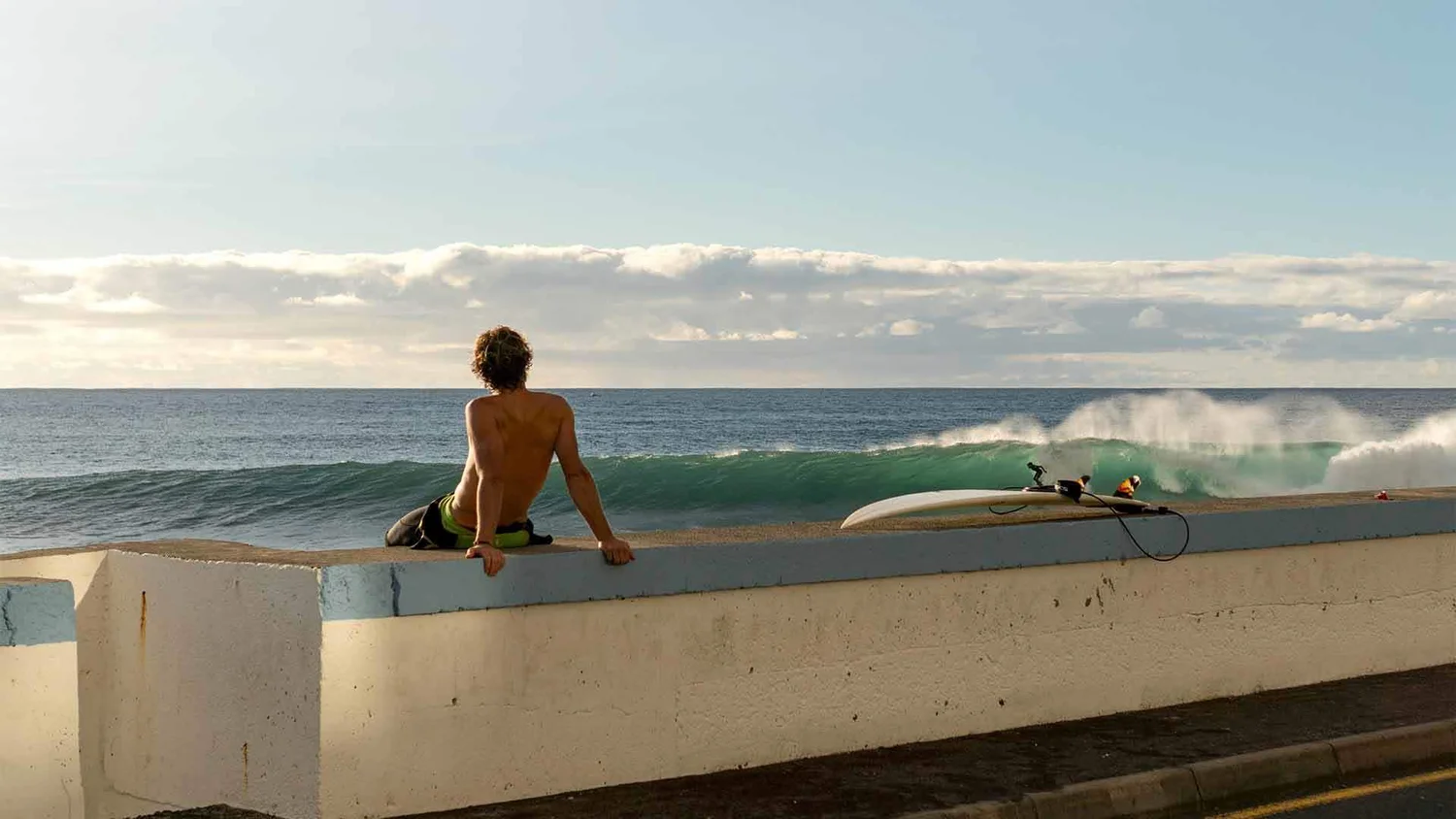 A surfer riding the reef break at Paúl do Mar