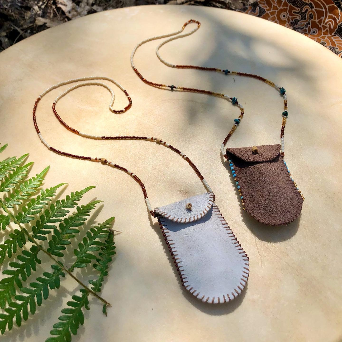 &bull;
✨Button-up + Beaded, Suede Medicine Pouch Neckpieces✨
Hand sewn Suede Leather strung with Glass Seed Beads, Bone &amp; Turquoise beads..

These two suede-babes are the largest in my recent Pouch Neckpiece collection. With the pouches themselve