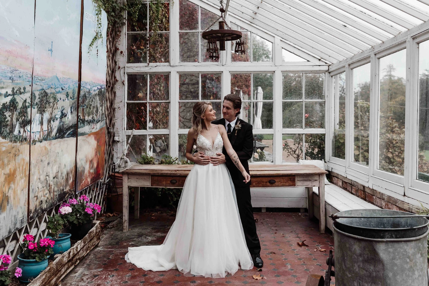Beautiful phot of a couple on their wedding day in Devon, taken in a glasshouse