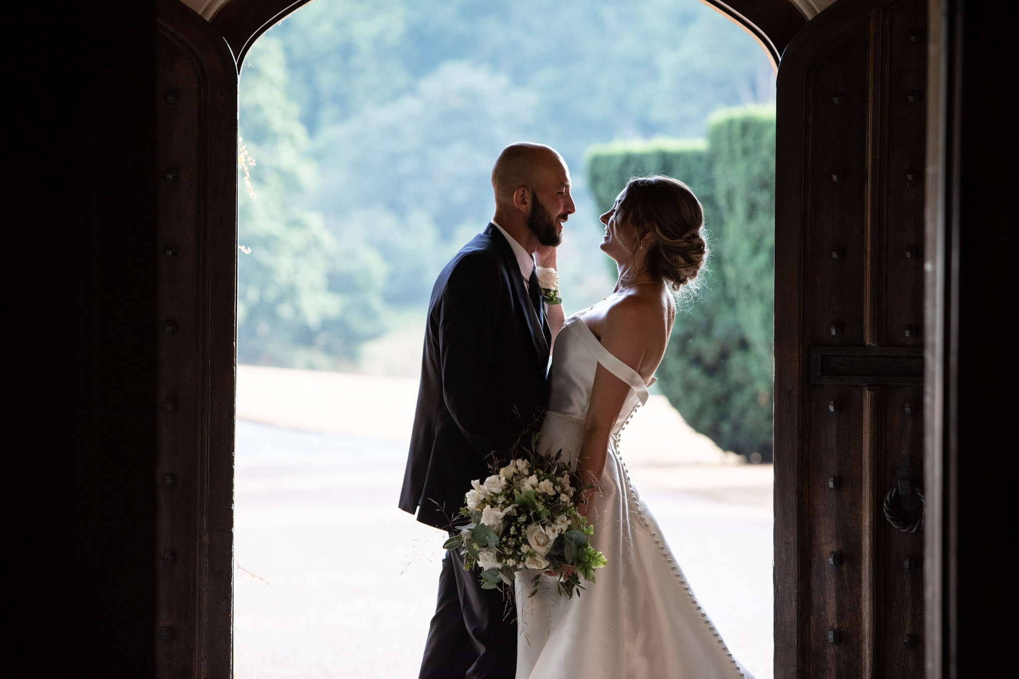 Newly married couple standing together in doorway at St Audries Park