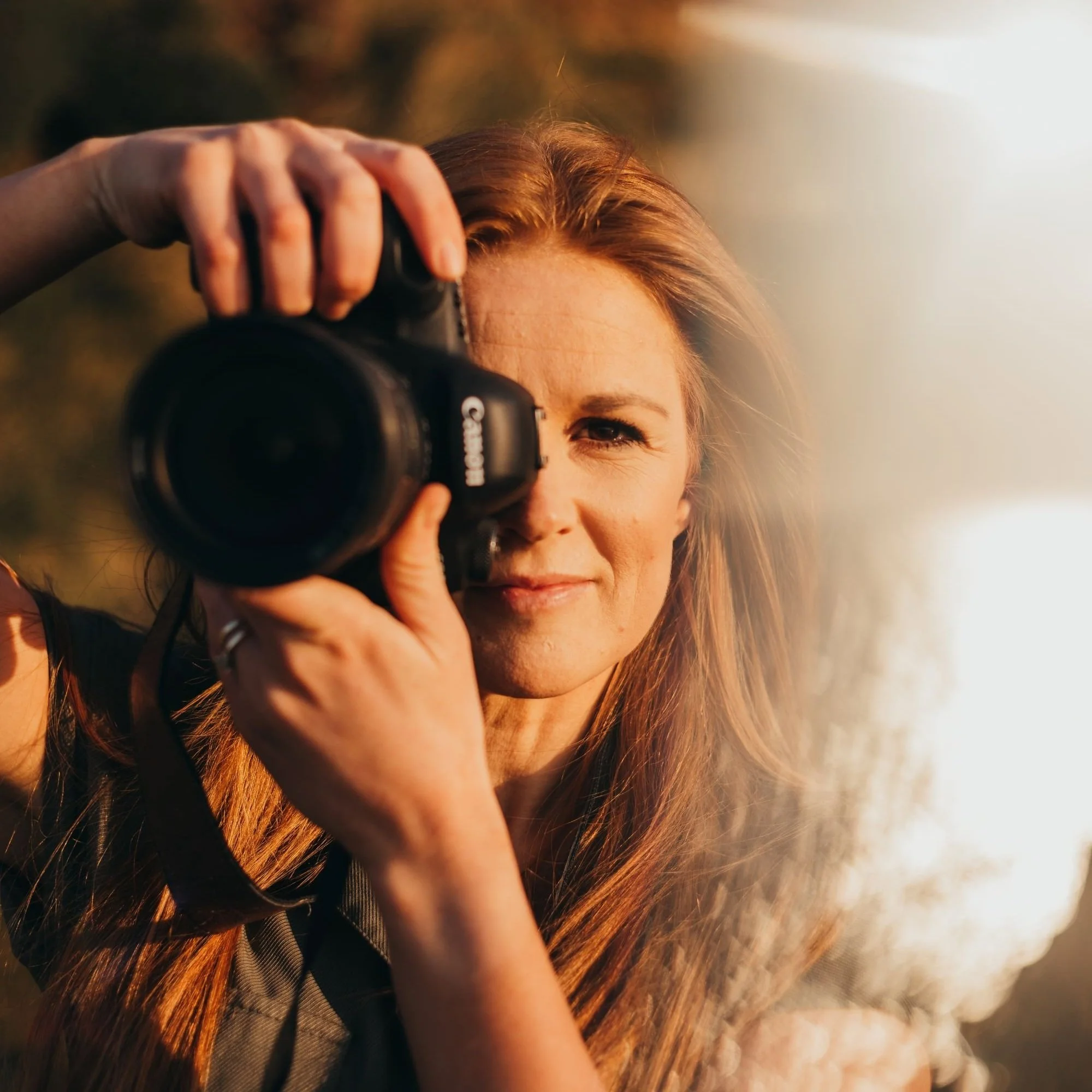 Kayleigh Lee, Snapdragon Photography, holding camera up to eye to take a photo