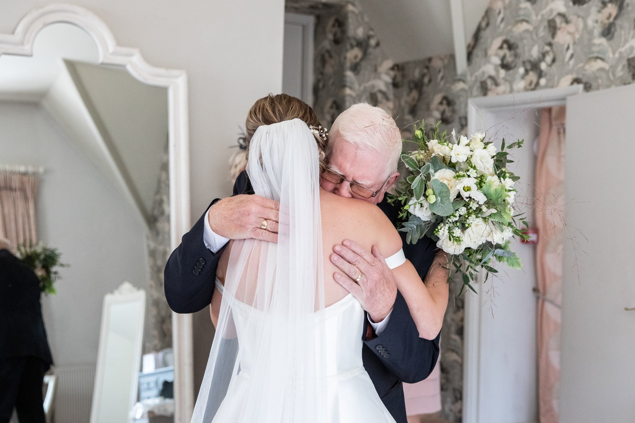 Bride and Father embracing during first look photos
