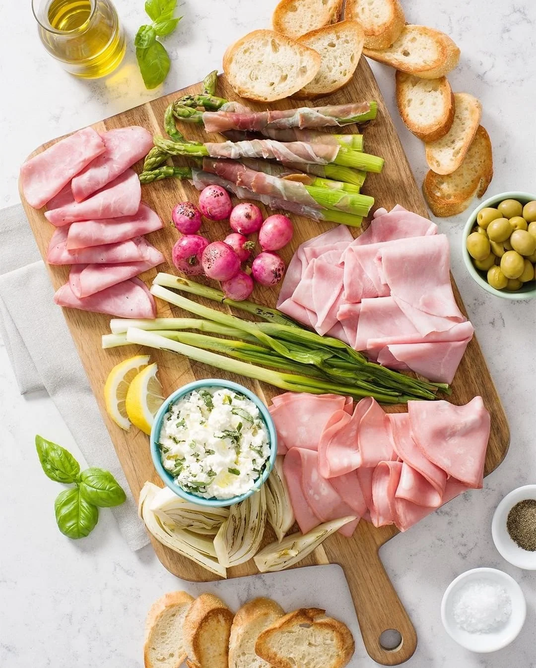 Charcuterie board with fresh veggies, Mastro and San Daniele deli meats, and delicious dips.