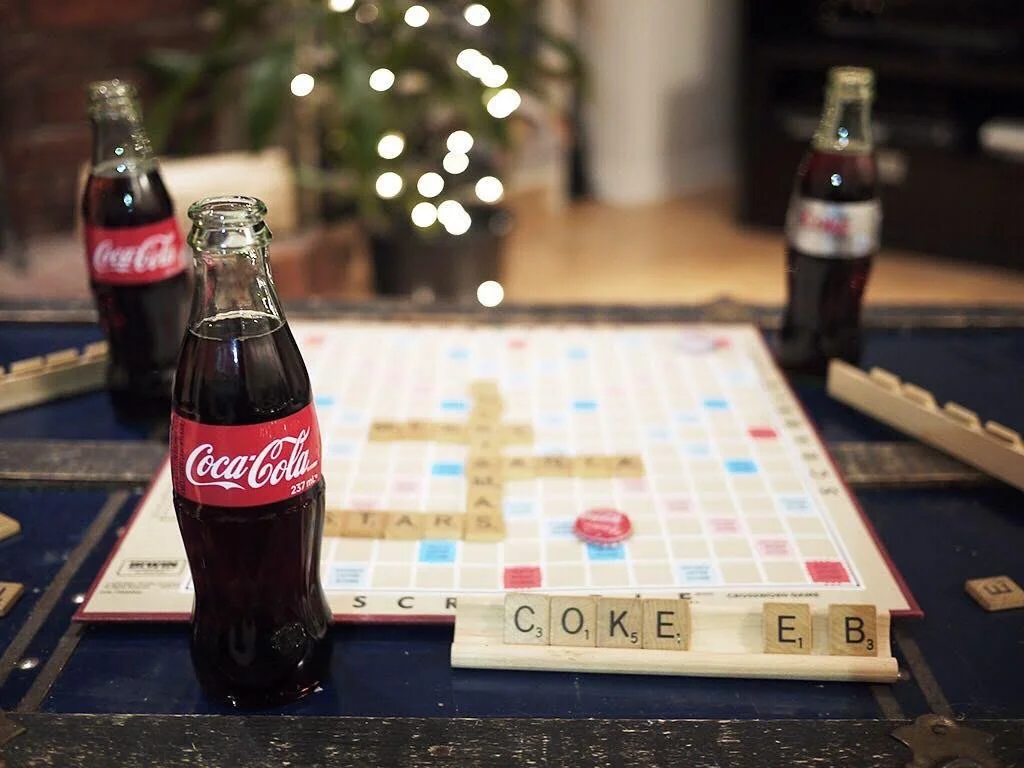 Playing a scrabble game with Coca-Cola and friends.