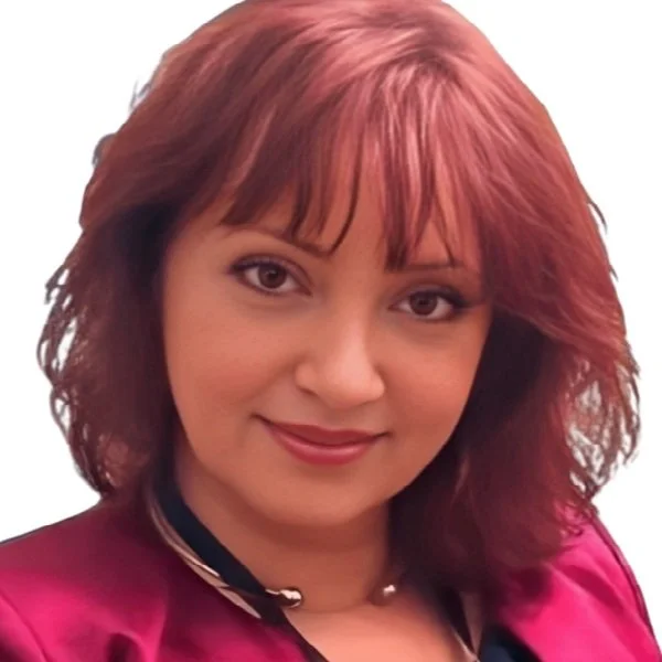 A woman with shoulder-length, reddish-brown hair and light makeup smiling at the camera.