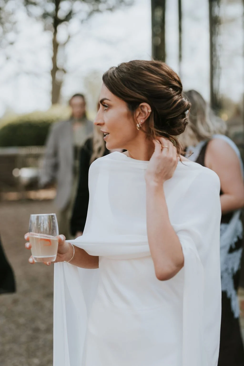 Bride enjoying champagne at her wedding reception at Aswarby Rectory in Lincolnshire.