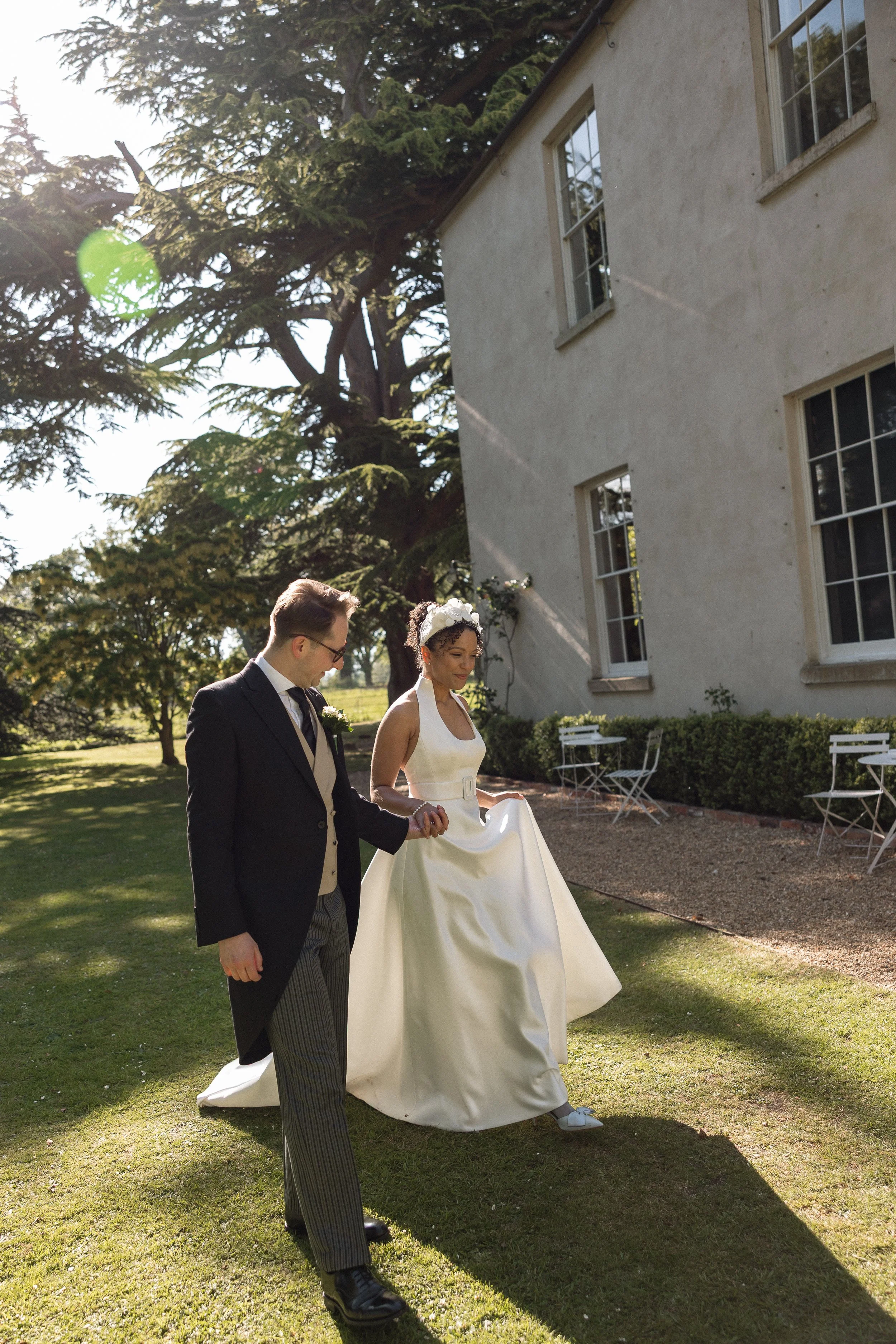 Bride Lauren and her husband standing outside Aswarby Rectory in Lincolnshire on their wedding day.