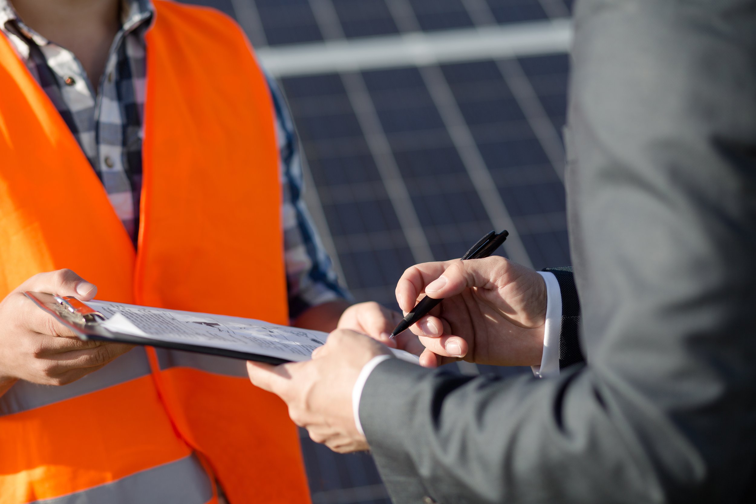close-up-view-foreman-client-sigining-contract-solar-power-station.jpg