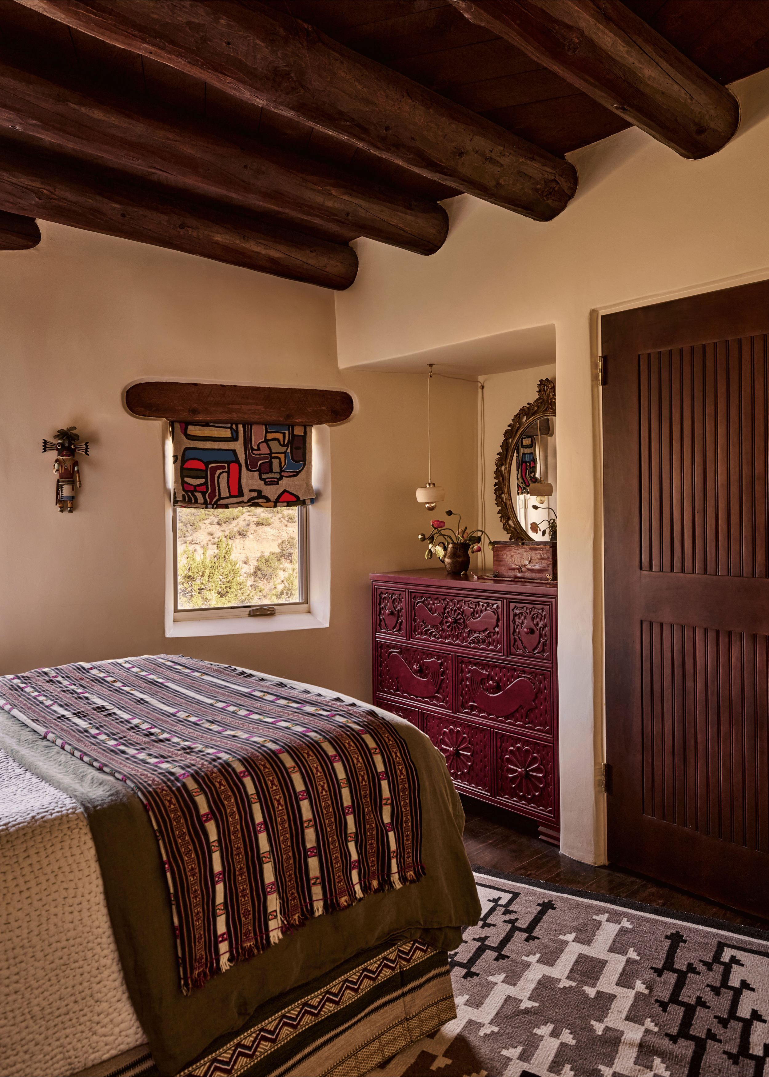 A carved magenta dresser, a bold abstract folk-print roman shade, and a striped woven blanket give this guest bedroom at the Mesa Project an energy entirely its own - French & French Interiors gives every room in the house a distinct point of view ra