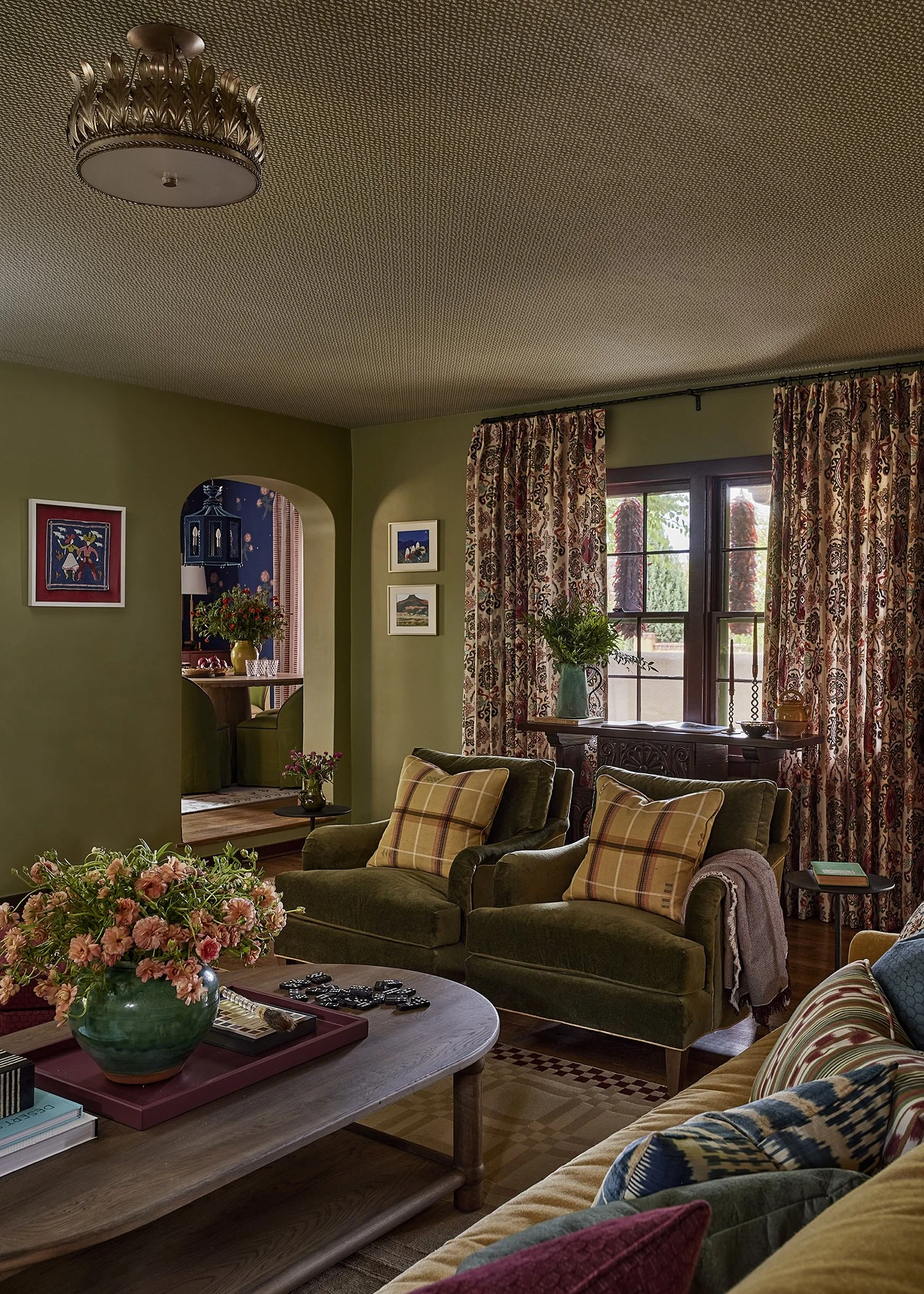 Cozy living room framed by arched walls and patterned curtains, a soulful Santa Fe interior by French & French Interiors.