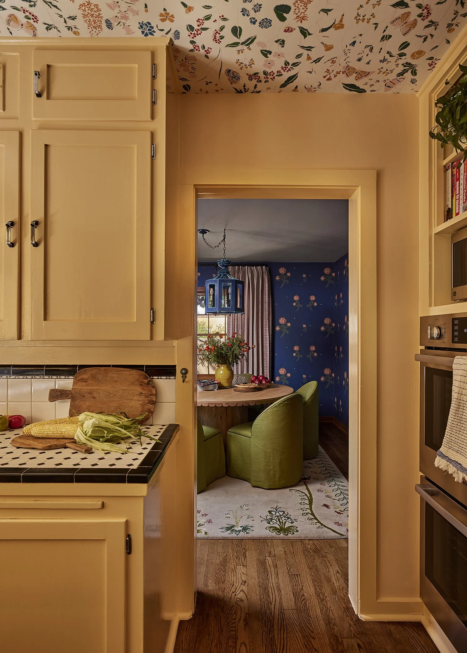 Warm kitchen view into a blue dining space, capturing French & French Interiors’ signature mix of color, craft, and comfort.