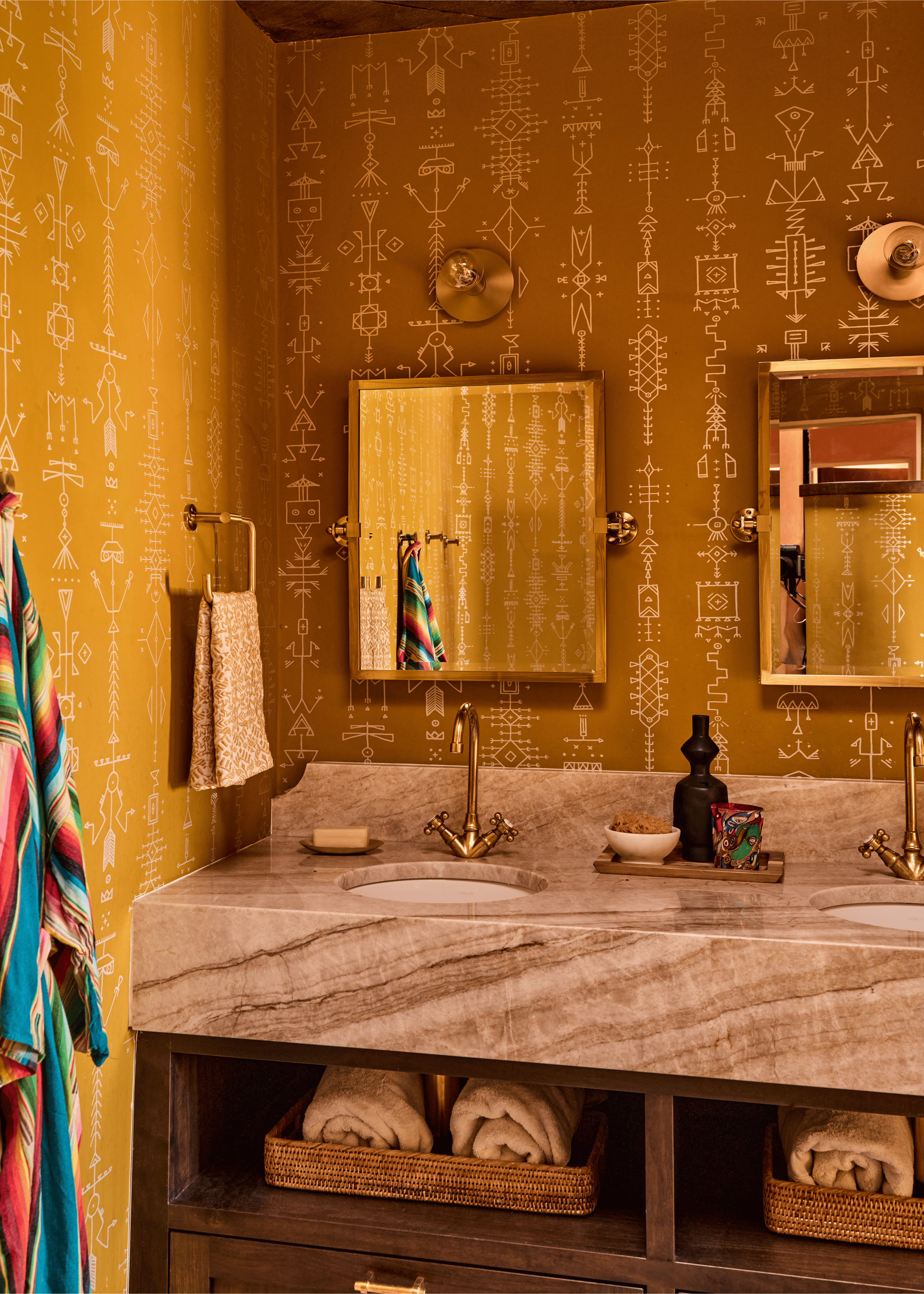 Floor-to-ceiling mustard geometric wallpaper, unlacquered brass faucets, and a book-matched marble double vanity transform this bathroom at the Mesa Project into one of the boldest rooms in the house - proof that French & French Interiors brings the 