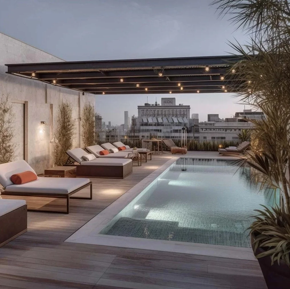 Luxury hotel rooftop pool in Madrid with wooden decking, designer sun loungers, and city skyline views at sunset