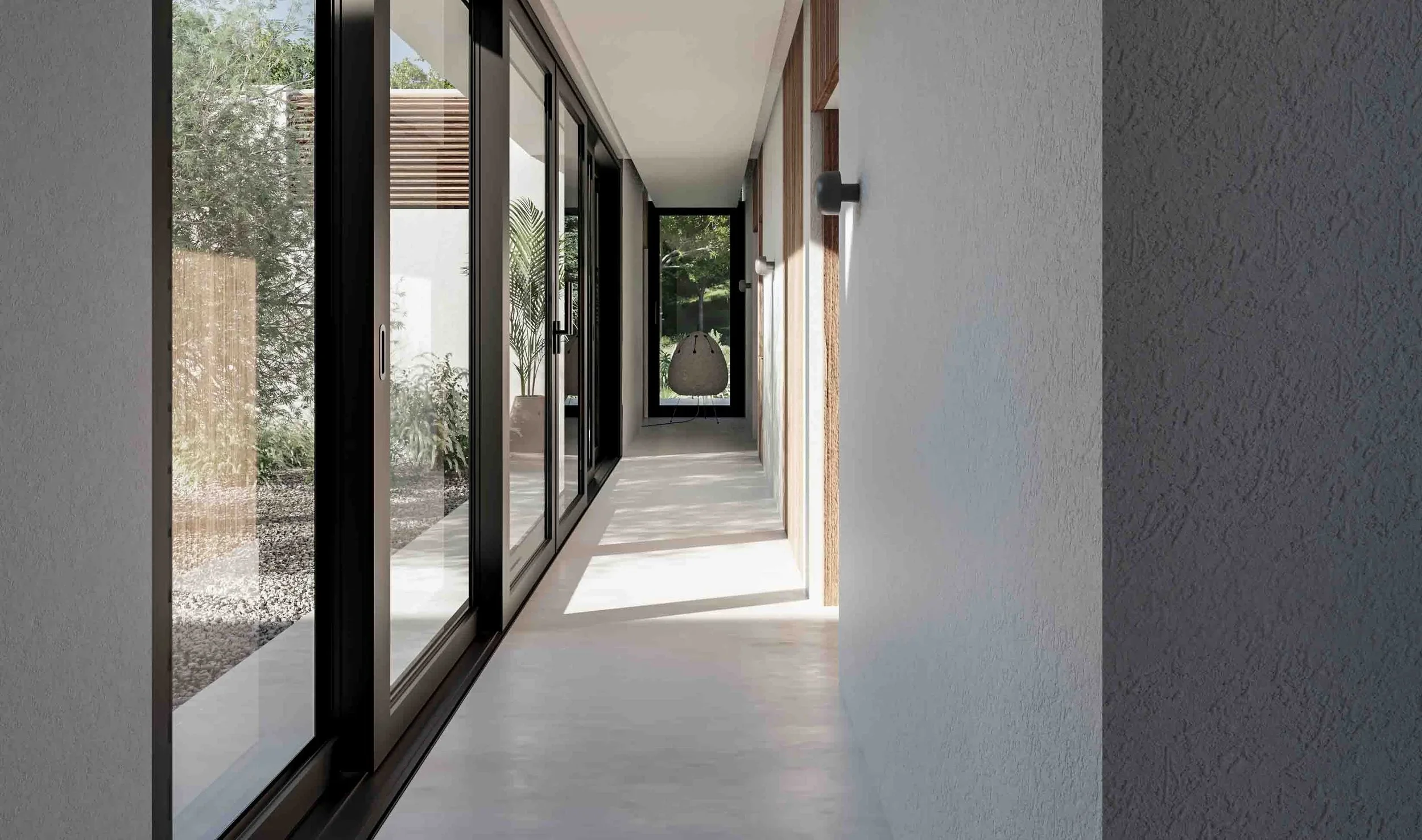 Minimalist luxury corridor with natural light play, featuring floor-to-ceiling glass doors and a seamless indoor-outdoor transition in a modern Mallorca villa.