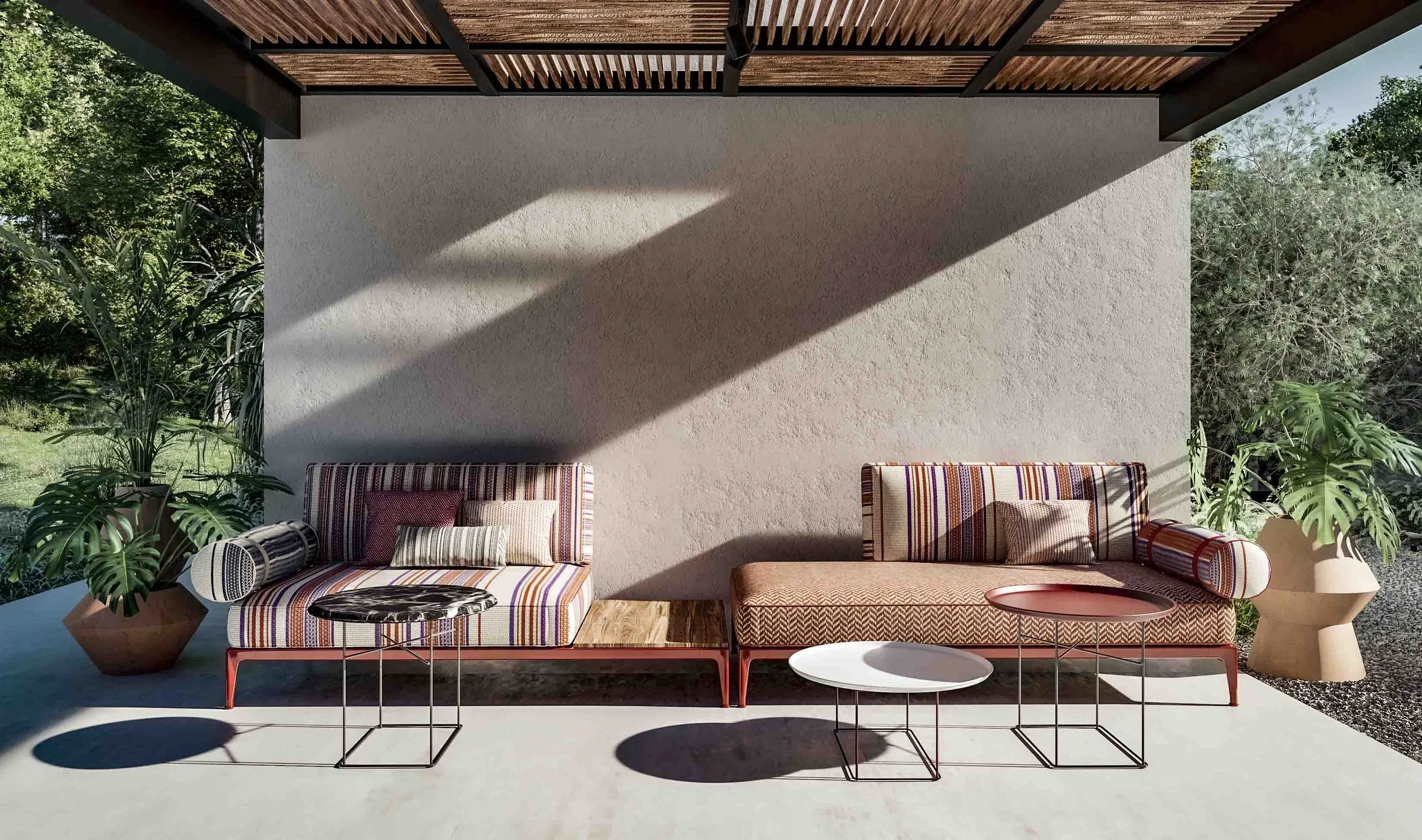 Detailed view of bespoke outdoor sofas with striped luxury upholstery and architectural lighting shadows on a private terrace in Mallorca.