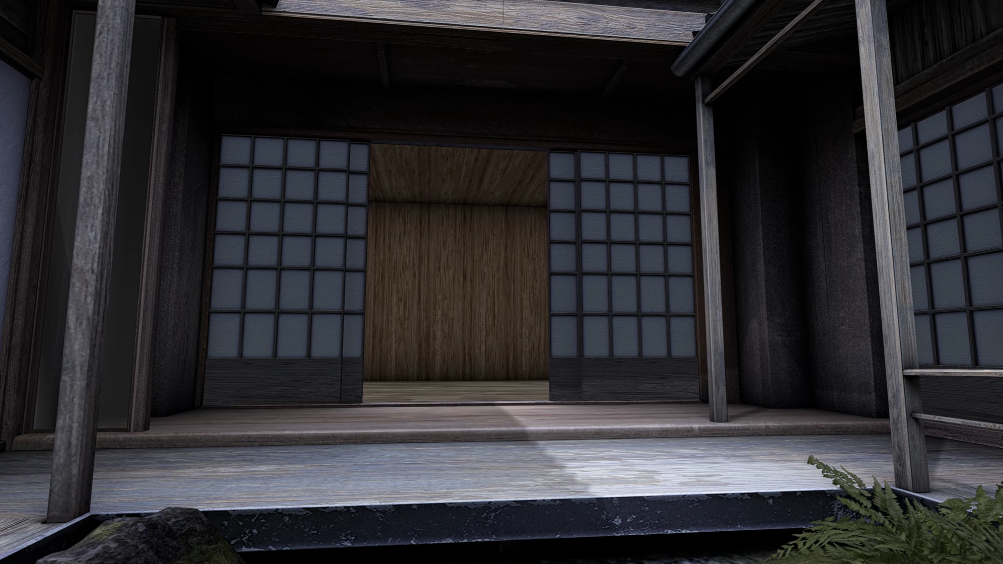 Scenic landscape with rolling green hills in the foreground and rugged mountains in the background under a clear sky.