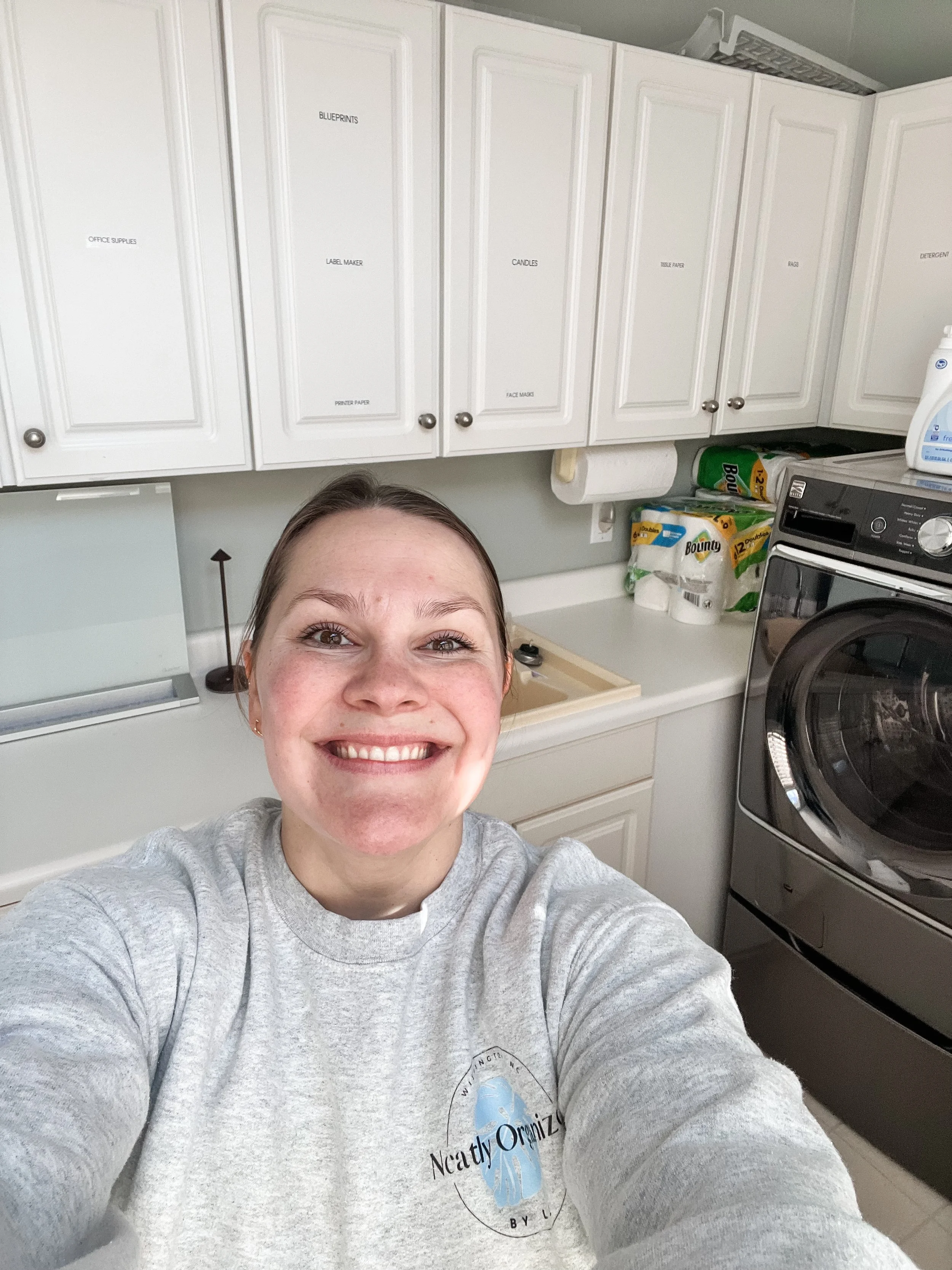 girl smiling in organized laundry room