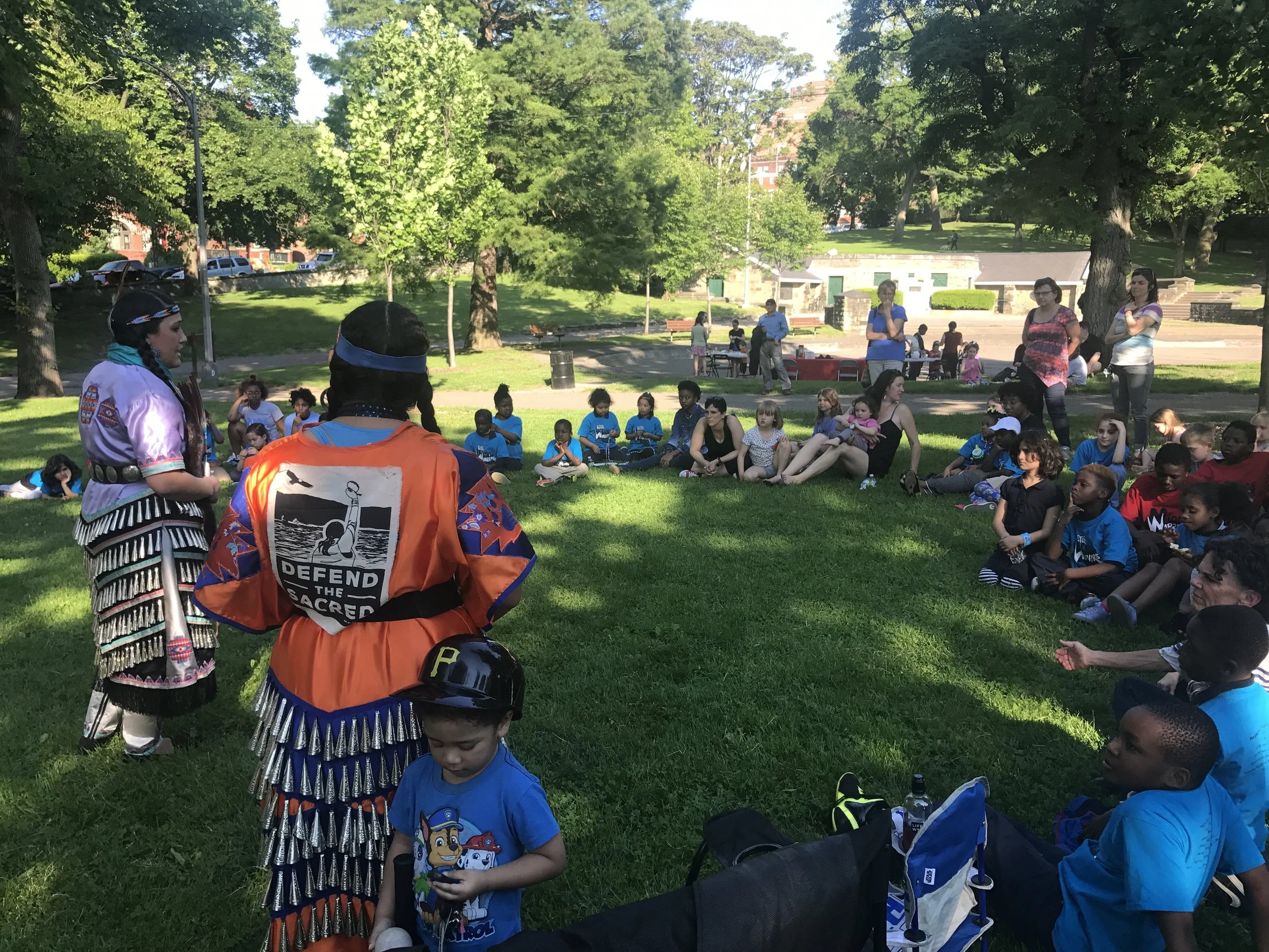 Neighbors and Arsenal Elementary Afterschool students enjoying Native American - Eastern Woodlands Tribe storytellers + dancers