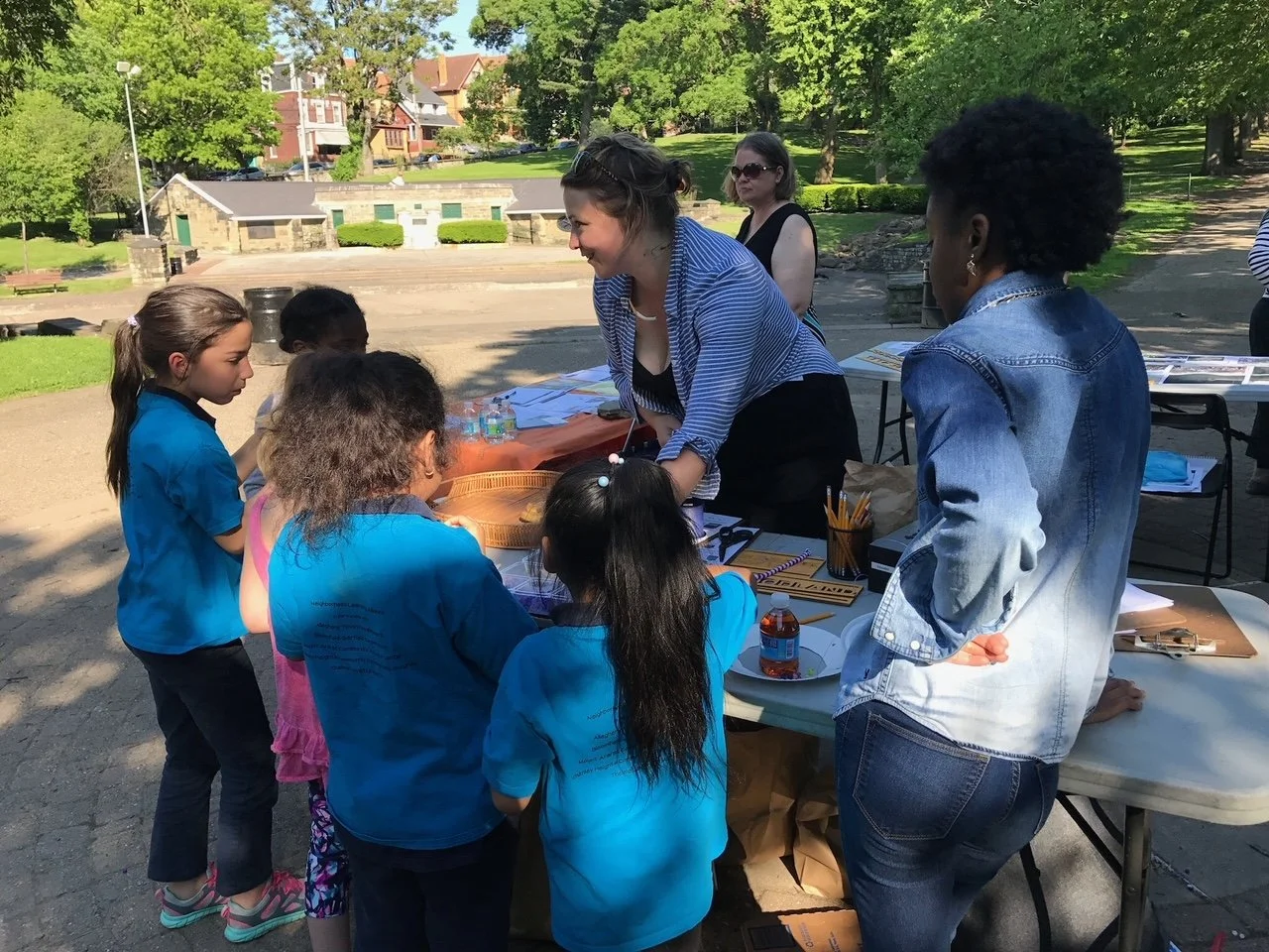 Heather with Arsenal Elementary students explaining park-wide scavenger hunt 
