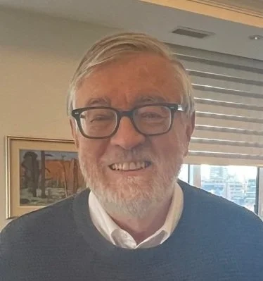 Smiling man with glasses.