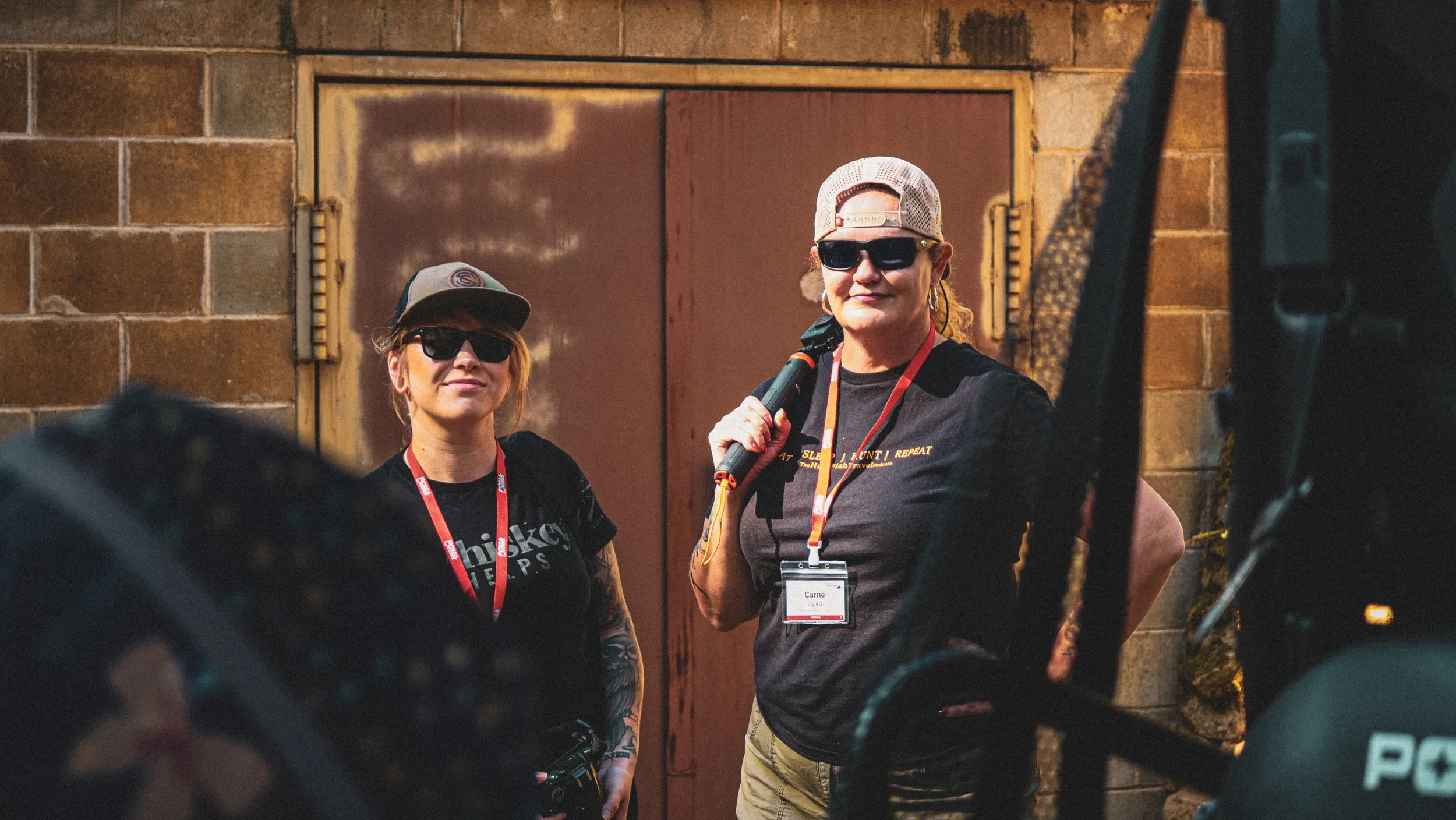 Women on gun range, at media event.