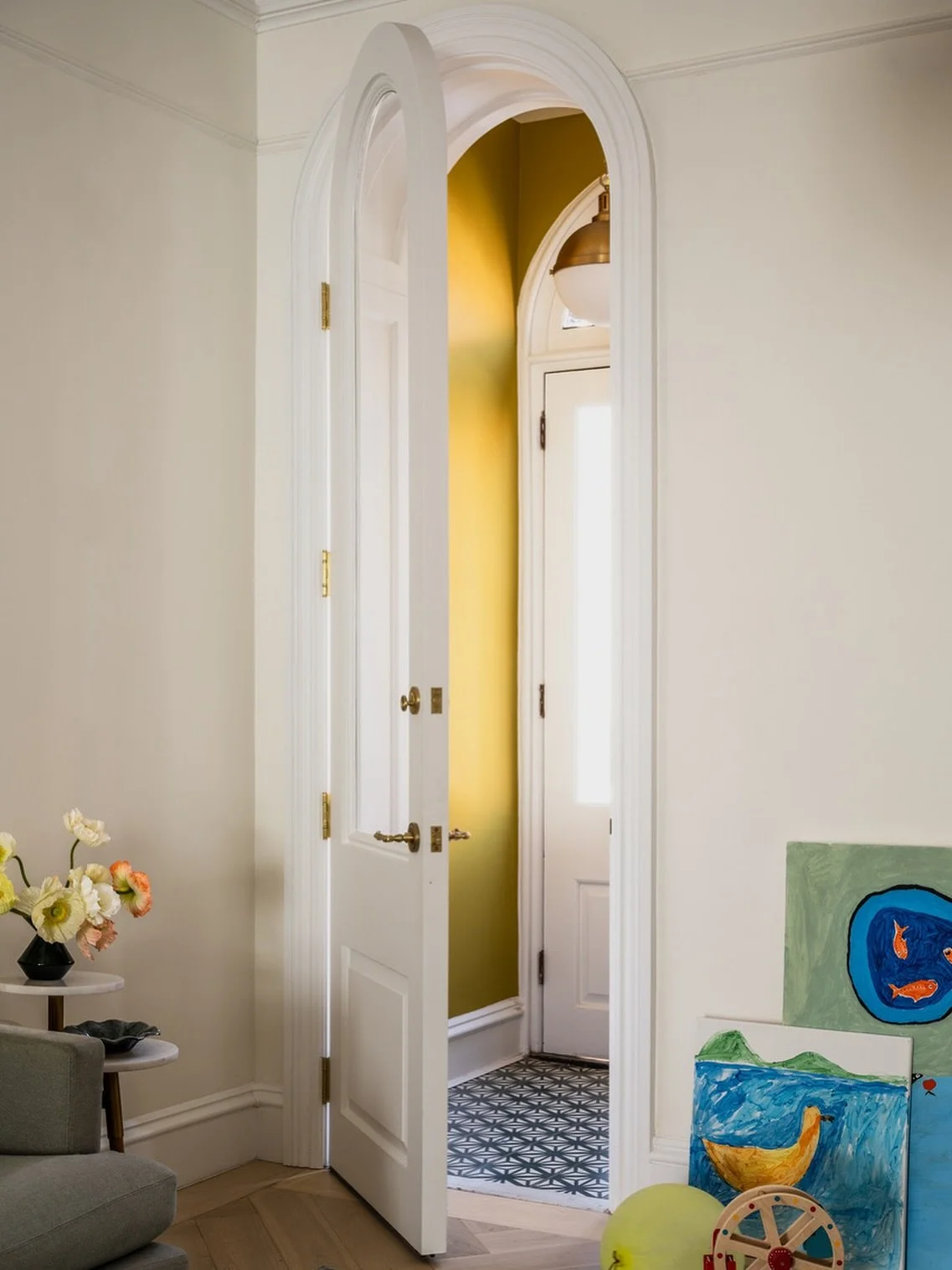 A new arched top vestibule door opens to the parlor from this inviting ochre vestibule at our #cobblehill remodel. 

#brooklynbrownstone #remodel #interiordesign #interiorsarchitecture #brooklynarchitecture #architecturelovers #remodeledhome #familyh