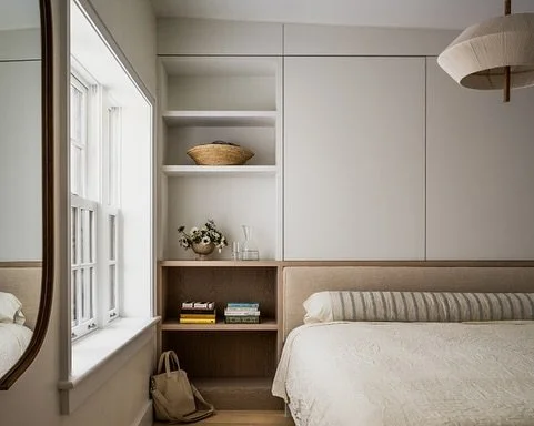 As seen in @brownstoner 
No inch of space is wasted at our Cobble Hill #brownstonerenovation project where we designed a custom upholstered and paneled headboard that conceals a secret cabinet built around a chimney. 

Photography - @atanz 
Styling -