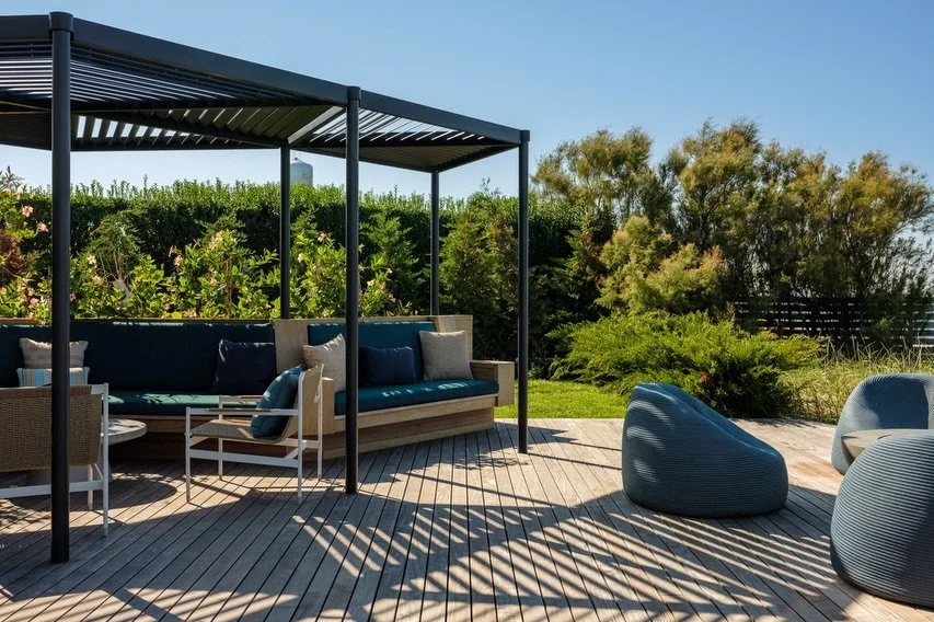 With 2 shade structures built into custom mahogany planter/ banquettes, we were able to create 2 distinct outdoor zones- one for lounging and one for dining at our Duneway #fireisland project. 
The modular geometry of the brise soleil create a play o