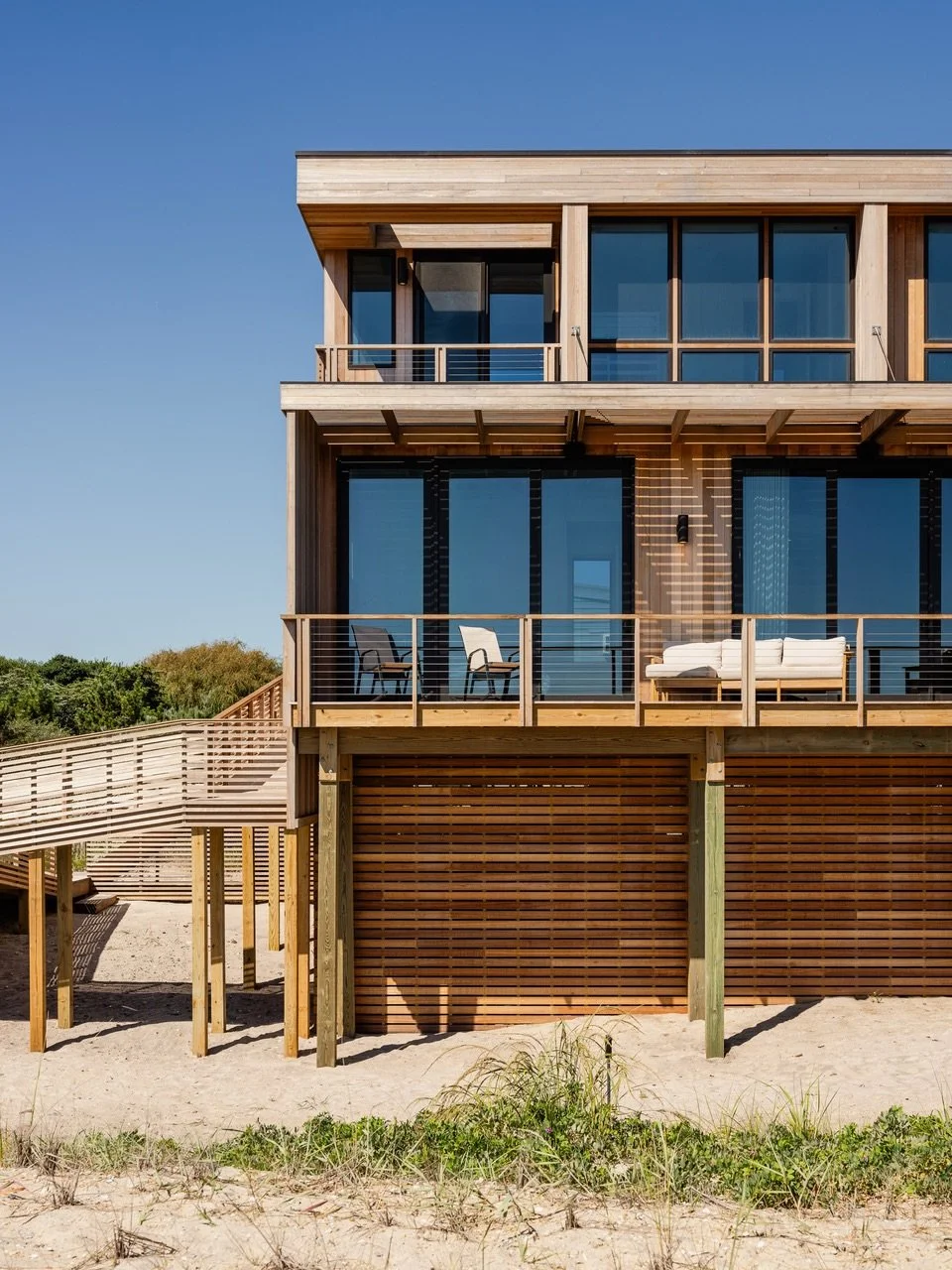 The exaggerated awning/ brise-soleil at our Surf Road project on #fireisland provides depth, dynamic shadows throughout the day, and a solid/ void texture that is repeated in the ceiling, railings, foundation and outdoor shower screening.

Architectu