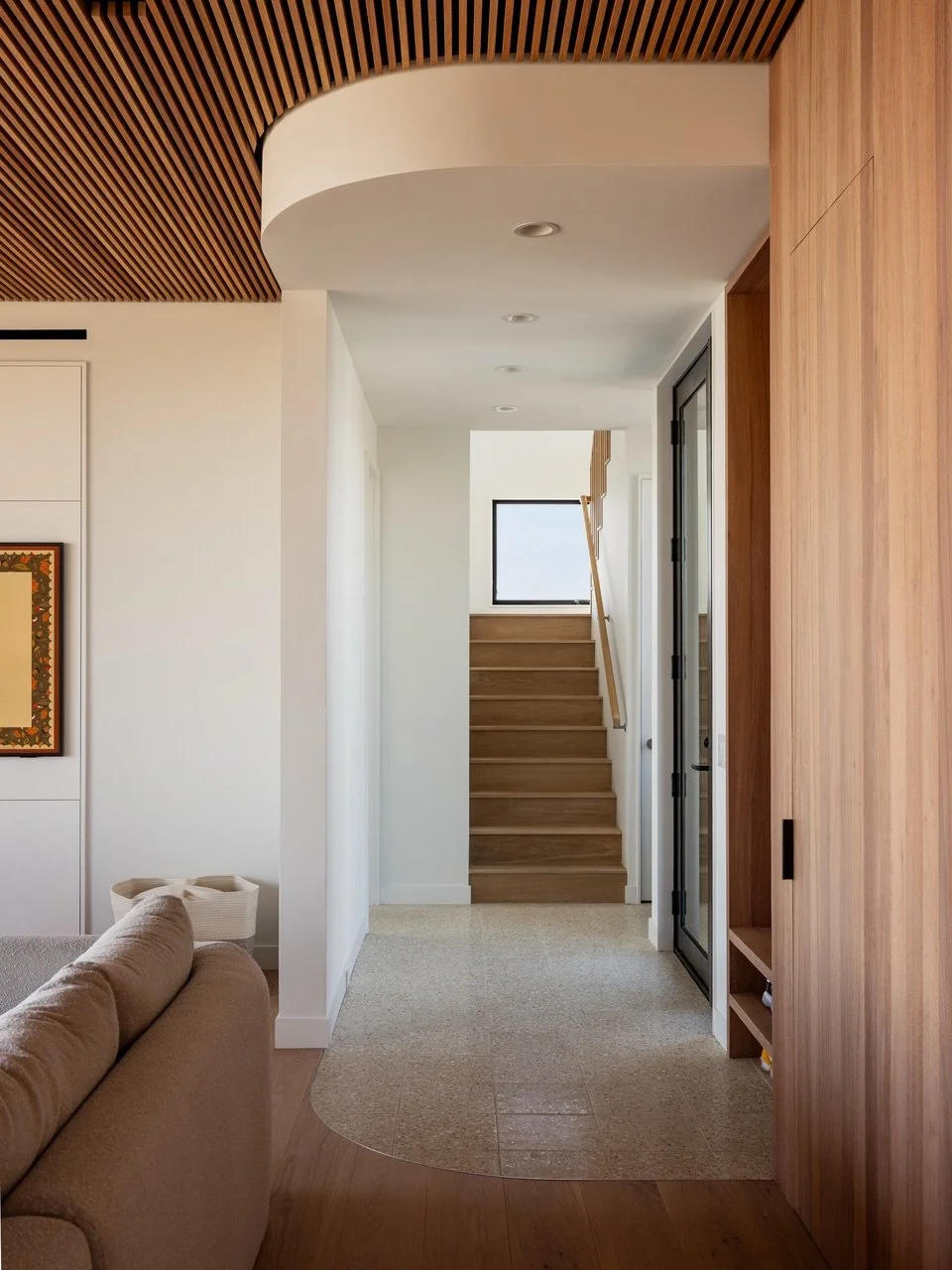 A couple of curves soften up all the straight lines at our Surf Road #fireisland project. The curved floor transition and ceiling soffit also create the threshold from entry area with built-in bench and storage to the main living space. Kudos to Isla