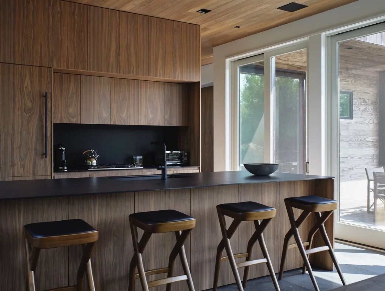 Not your average #beachhouse interior. Rich walnut and  basalt grace the kitchen and living area of our Juniper House project on #fireisland 

Architecture and interiors - @coughlinscheel 
Build - Island Contracting 
Wood siding, floors &amp; ceiling
