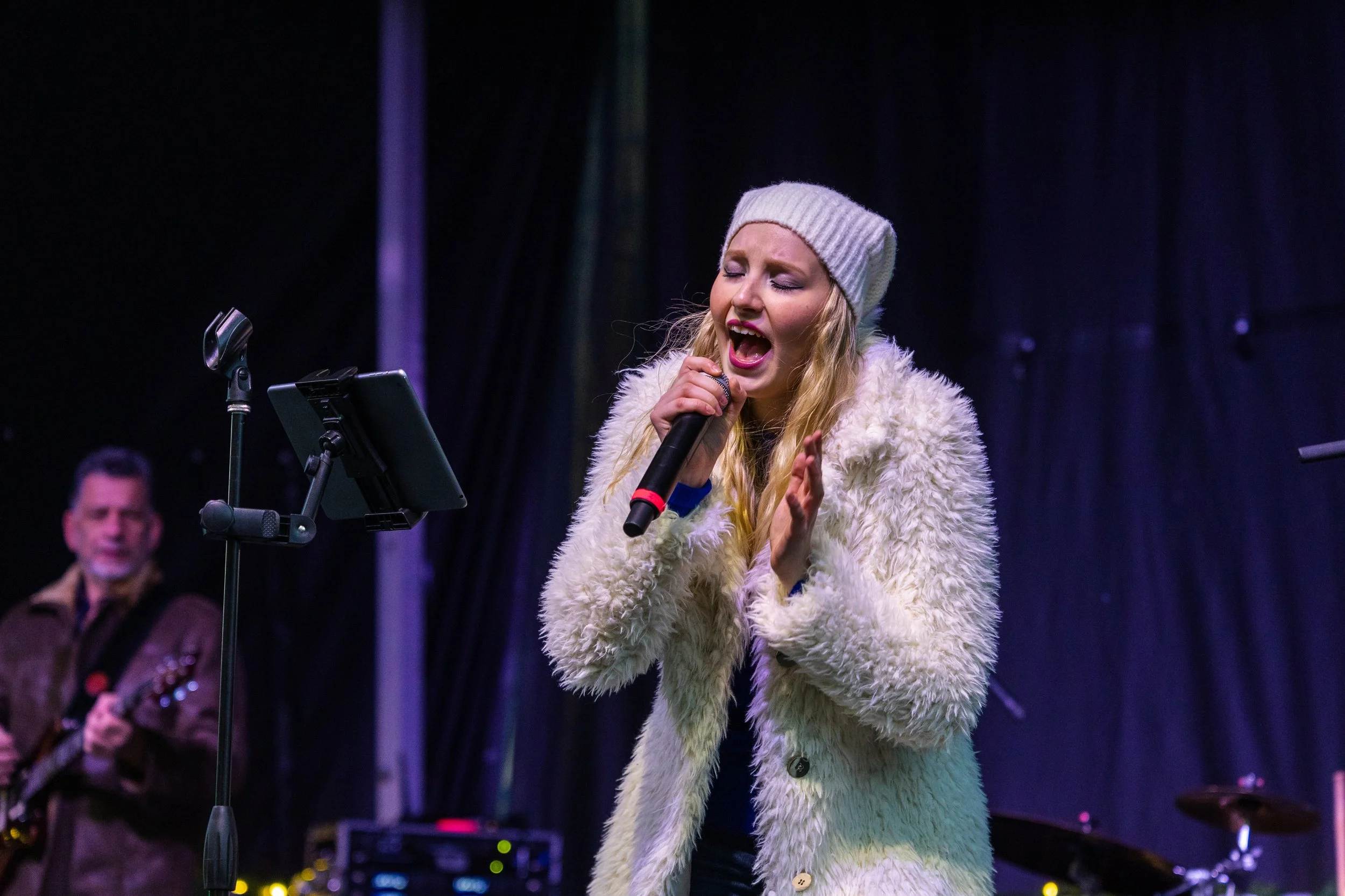 Singer performing on stage during an Upstate New York event