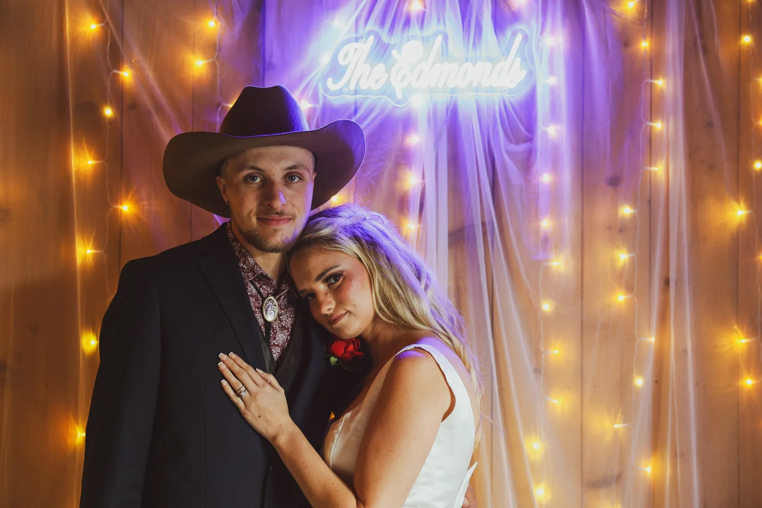 Newlyweds portrait beneath reception lights