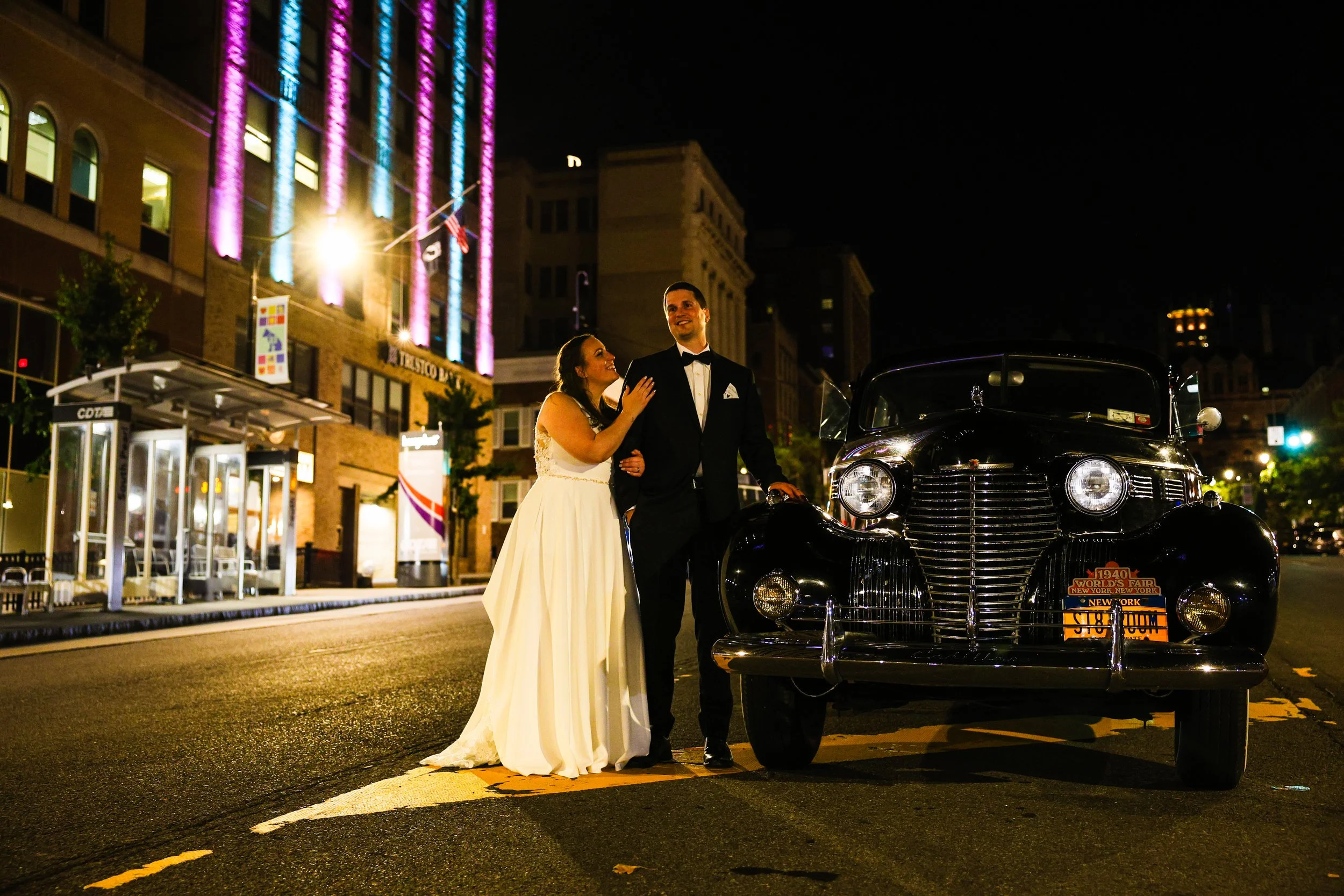 Newlyweds with a classic car at night in Albany New York