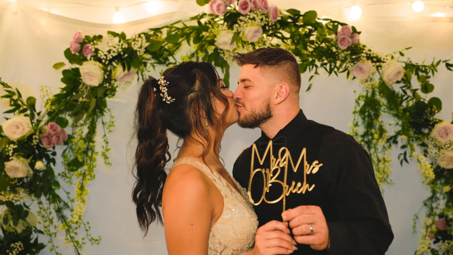 Newlyweds kissing at their wedding reception