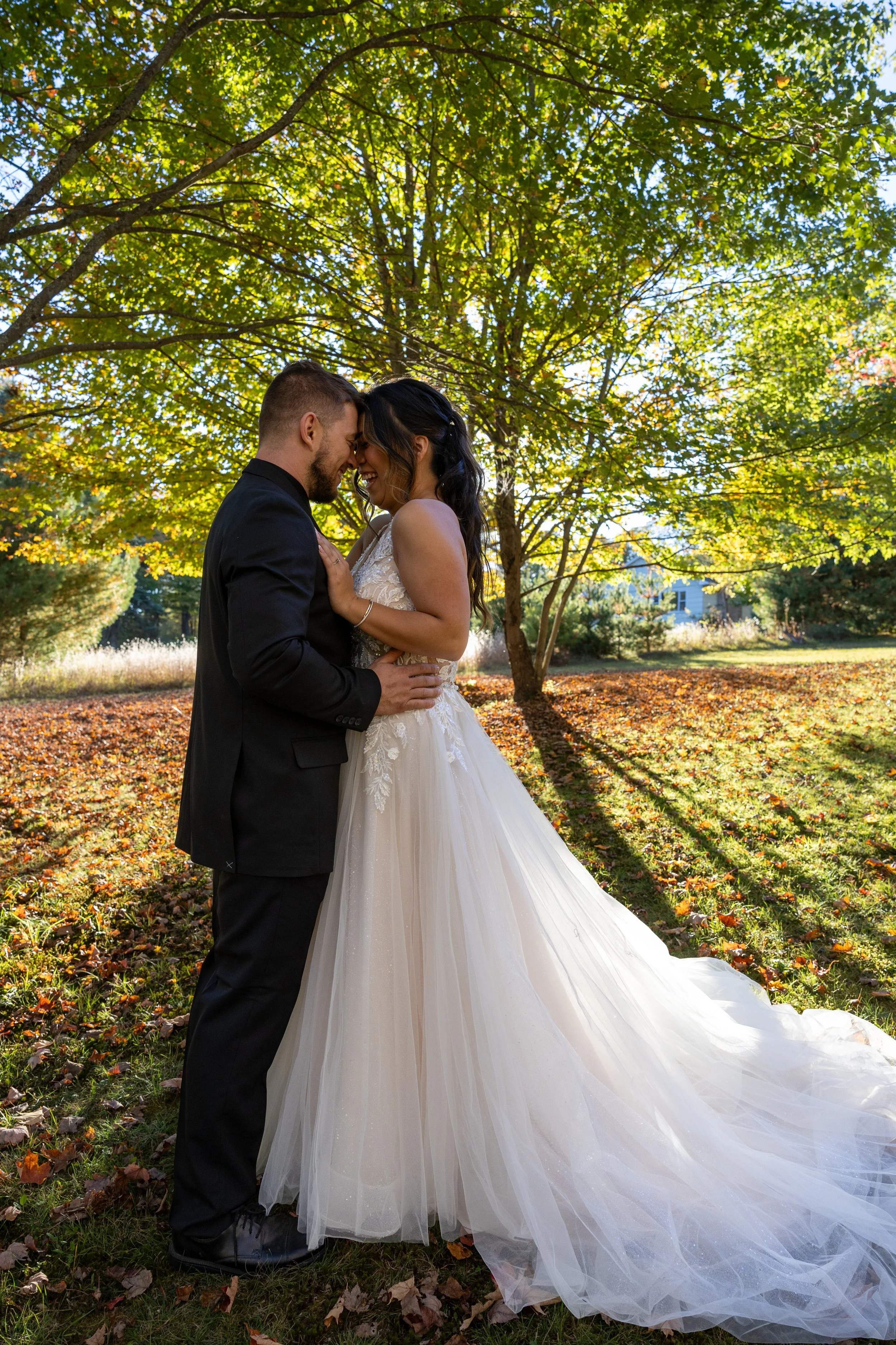 Bride and groom together in autumn light