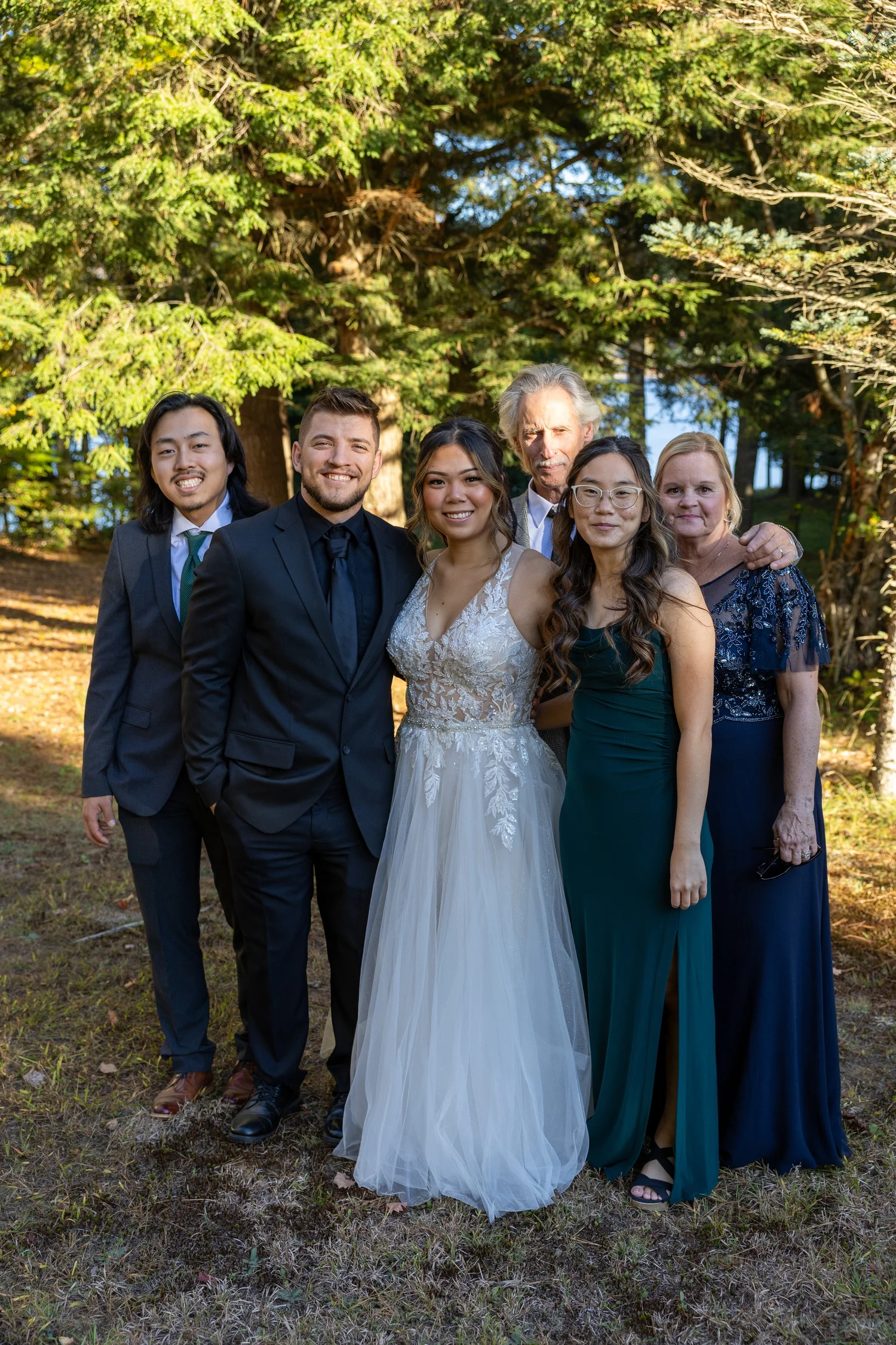 Wedding couple with family outdoors