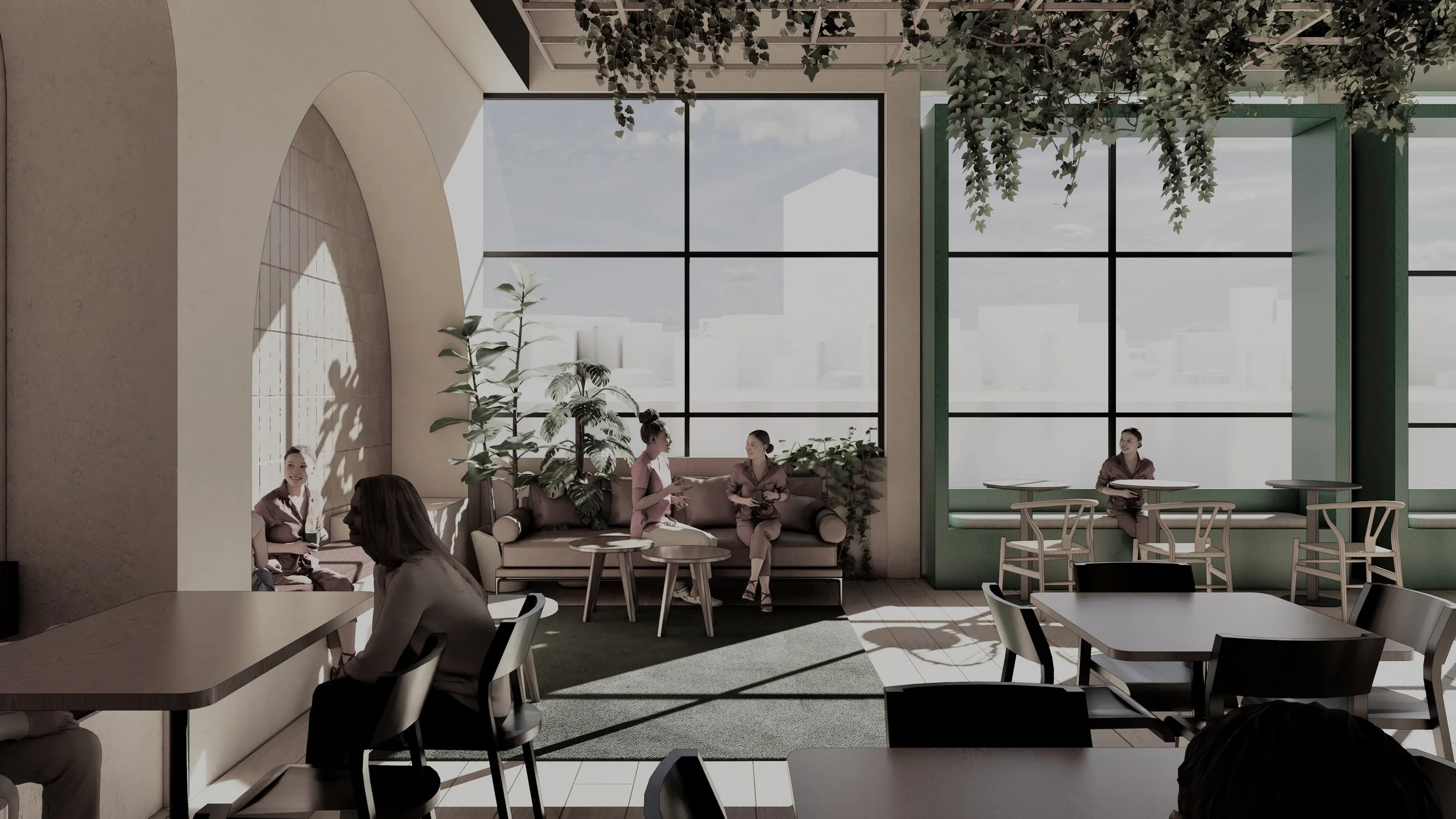 Interior of a modern cafe with large windows, potted plants, and several people sitting and talking, some at tables and some on a couch.