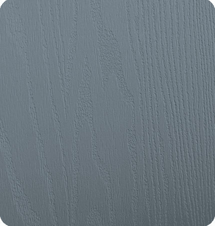 Close-up of a gray wooden surface with visible wood grain texture.