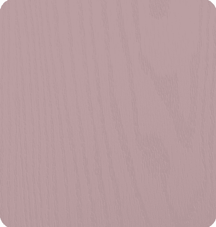 Close-up of a light pink wooden surface with visible wood grain.