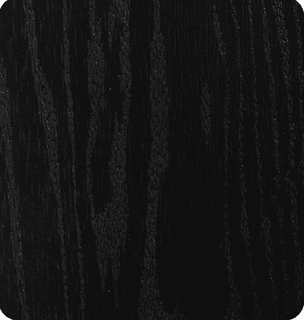 Close-up of a black wooden surface with visible grain texture.
